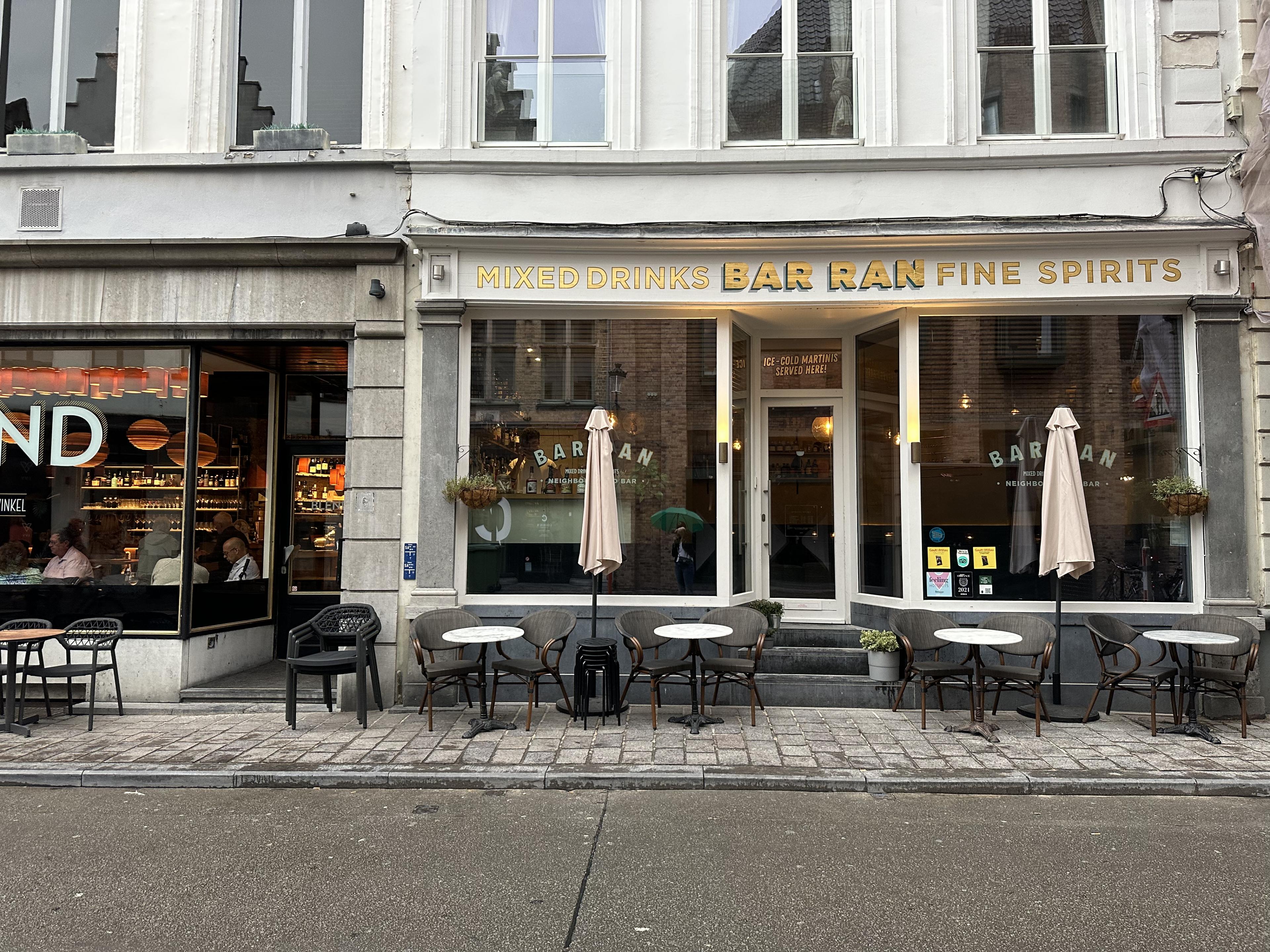 sleek white restaurant exterior with gold lettering