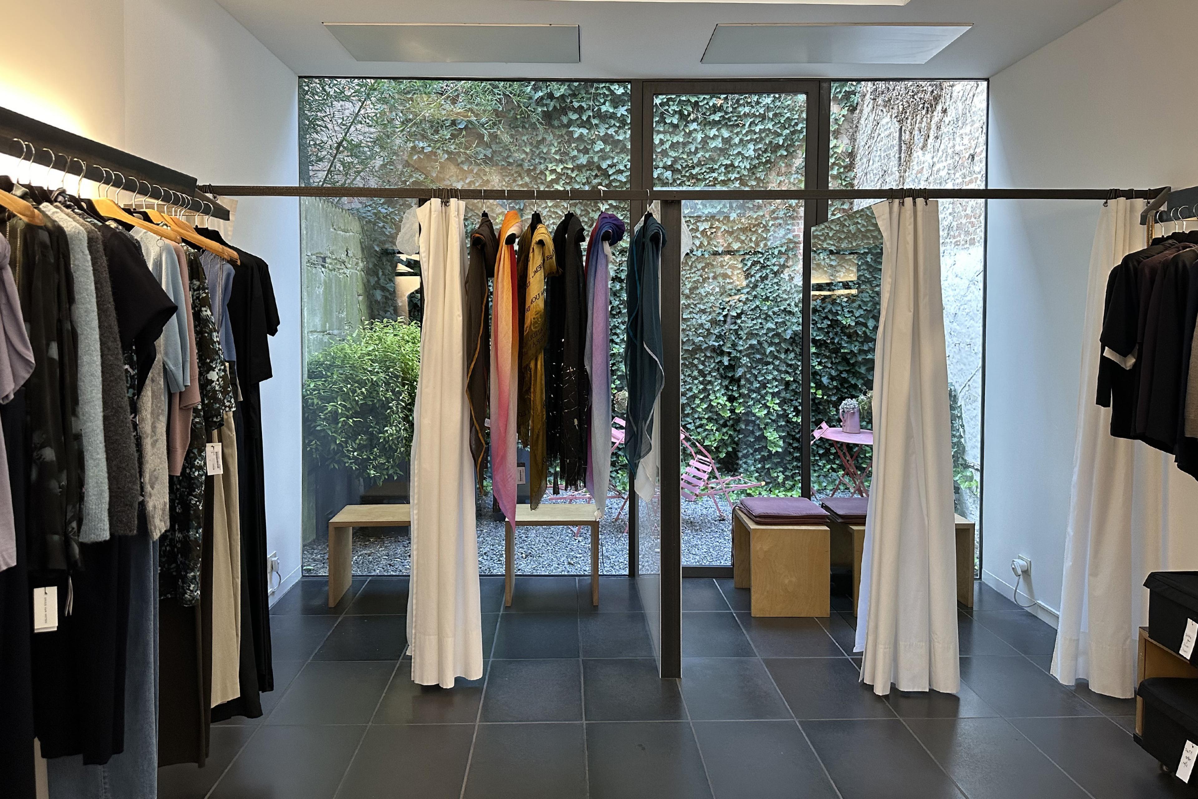 Clothing boutique interior with black racks