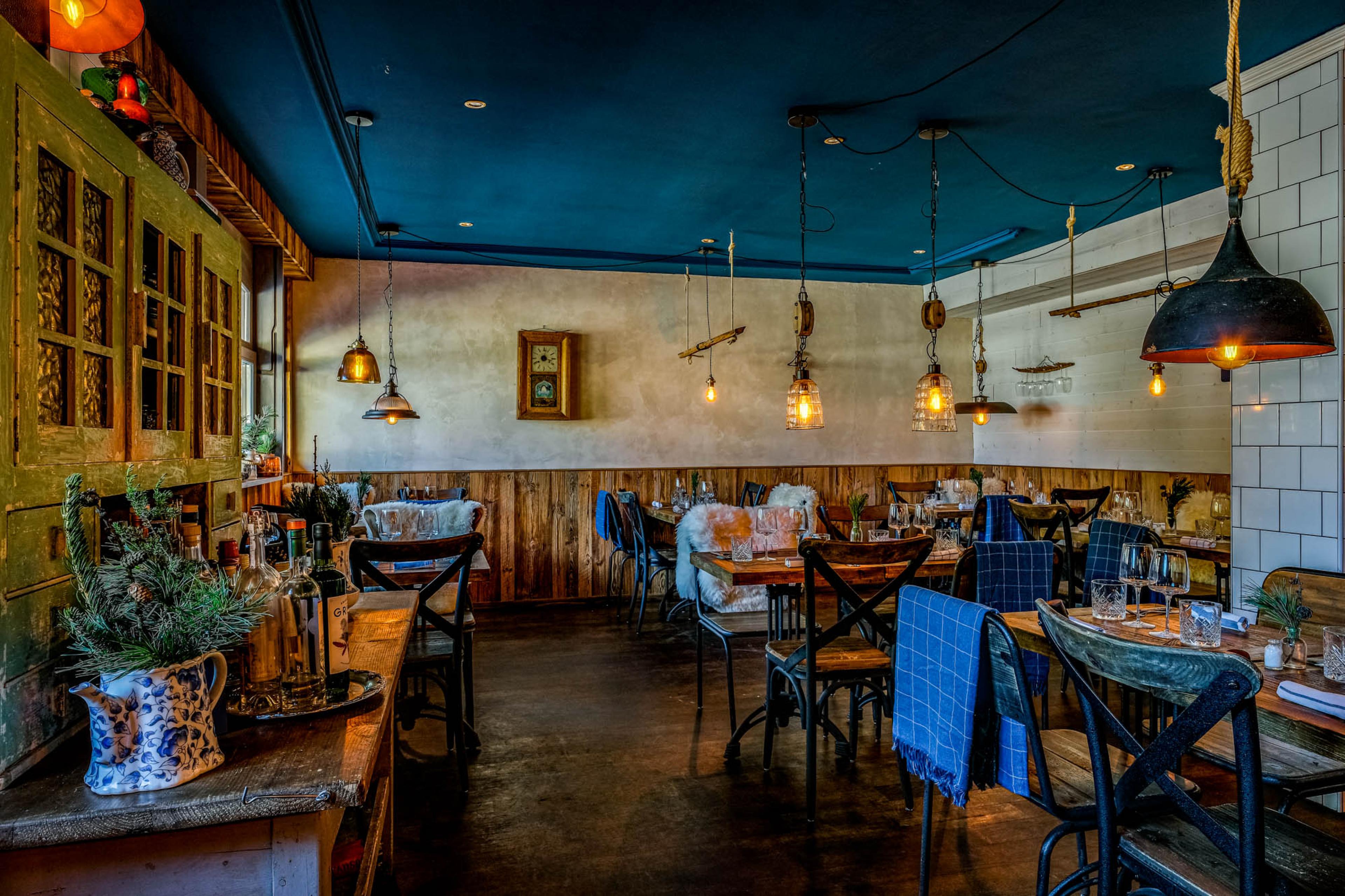 inside of a small laid-back alpine restaurant with wooden tables