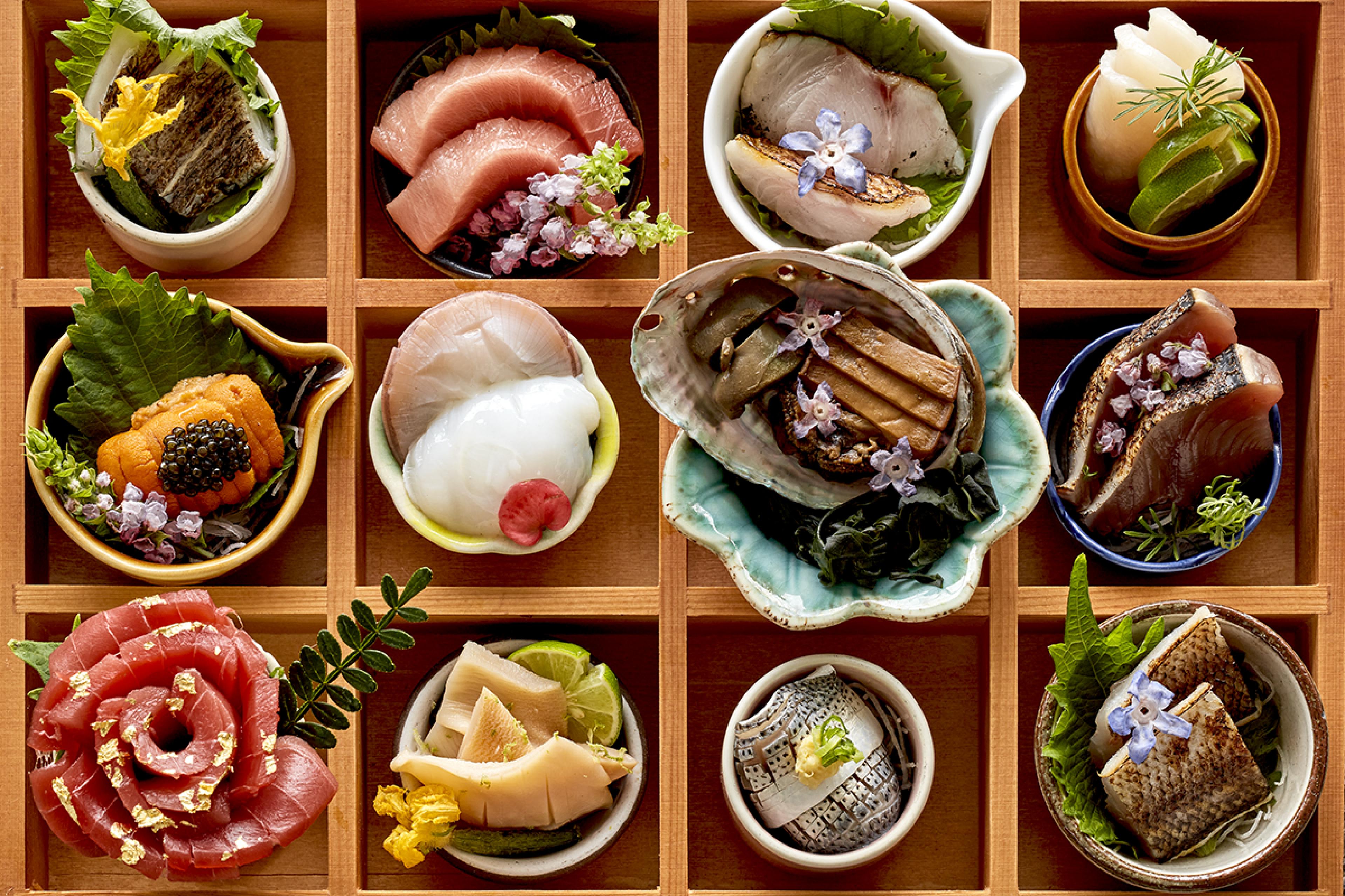 overhead view of lots of sushi in fancy wooden tray