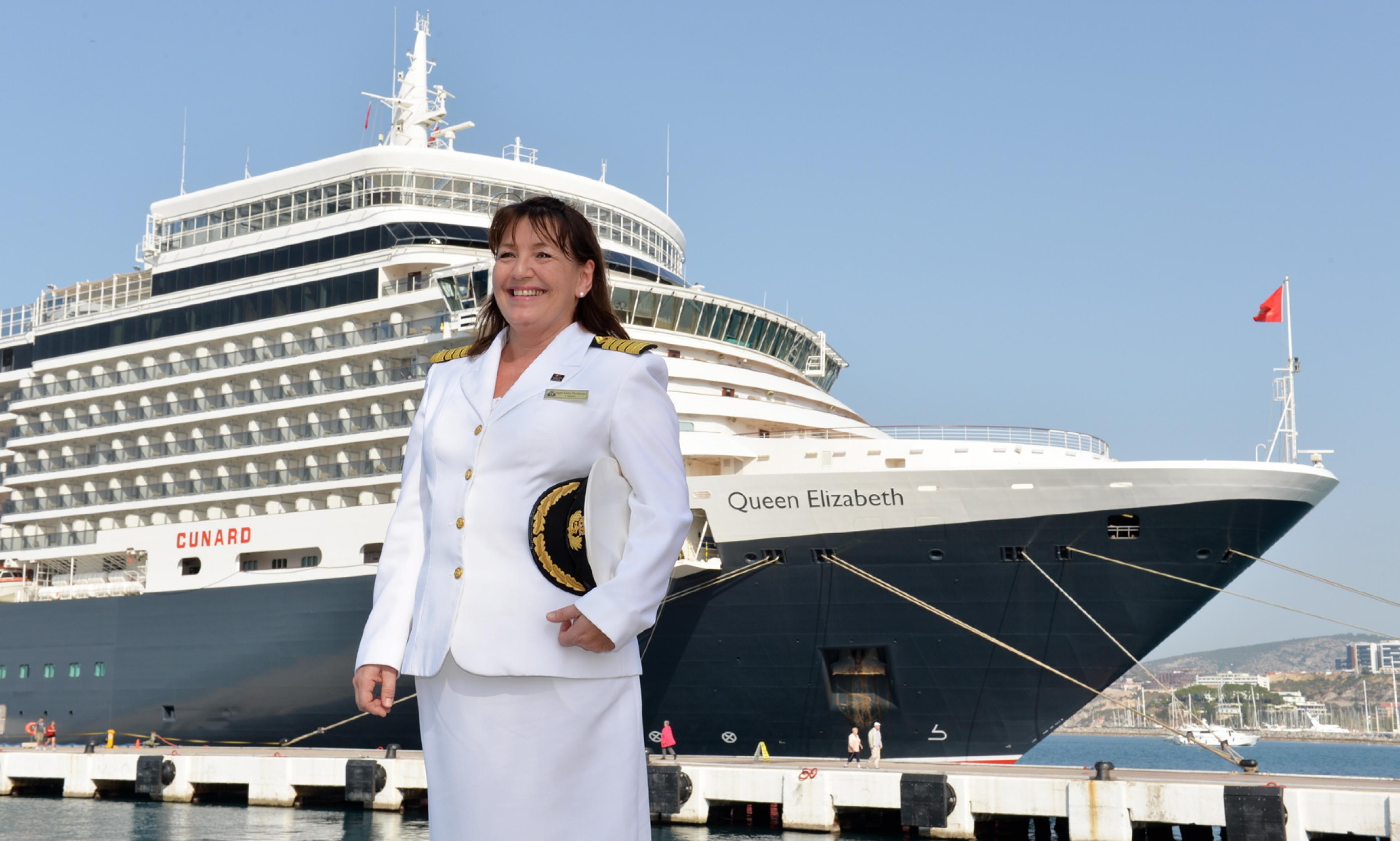 Captain Thorhauge standing in front of Queen Elizabeth cruise ship of the British Cruise Line Cunard