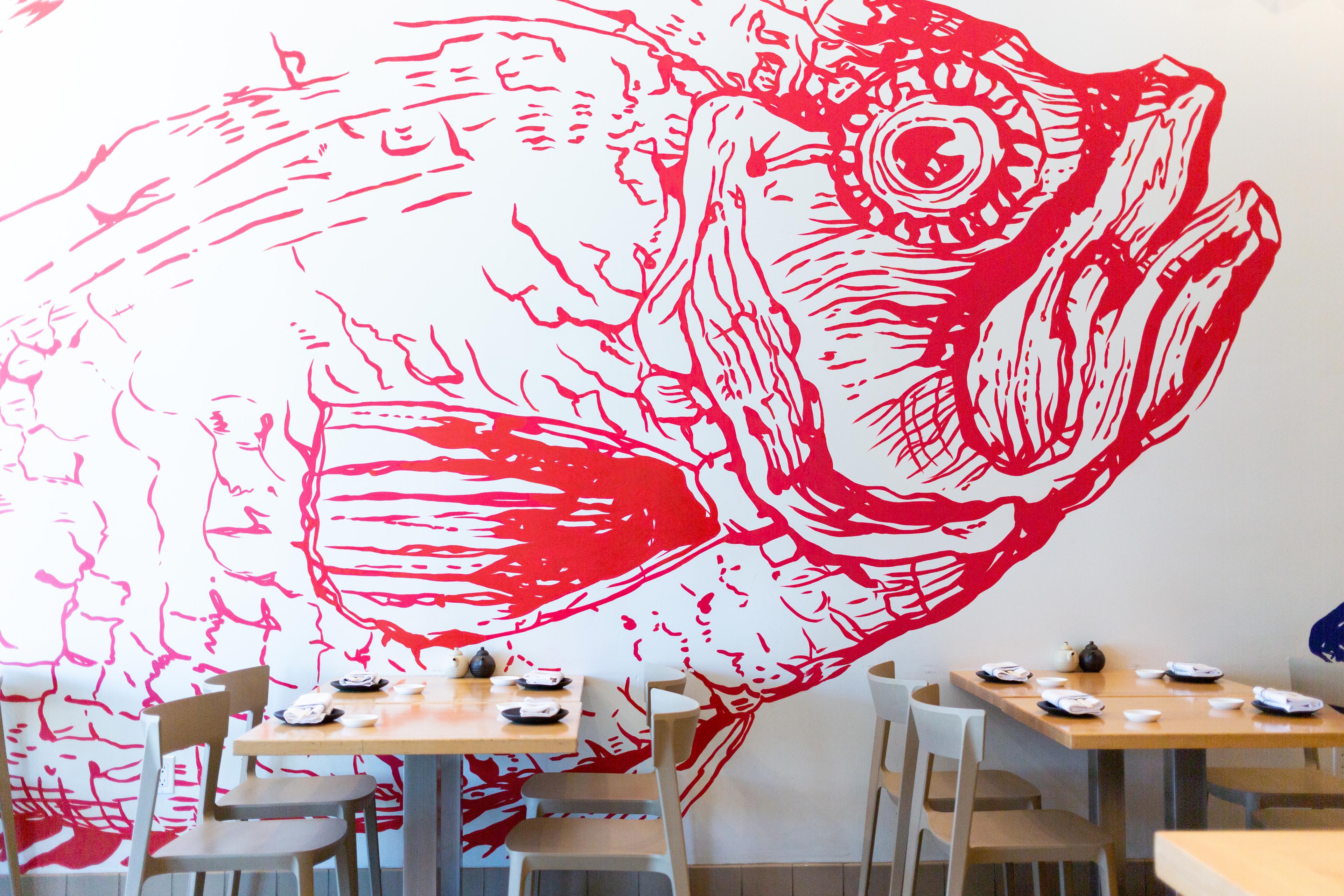 White wall with a red fish outline
