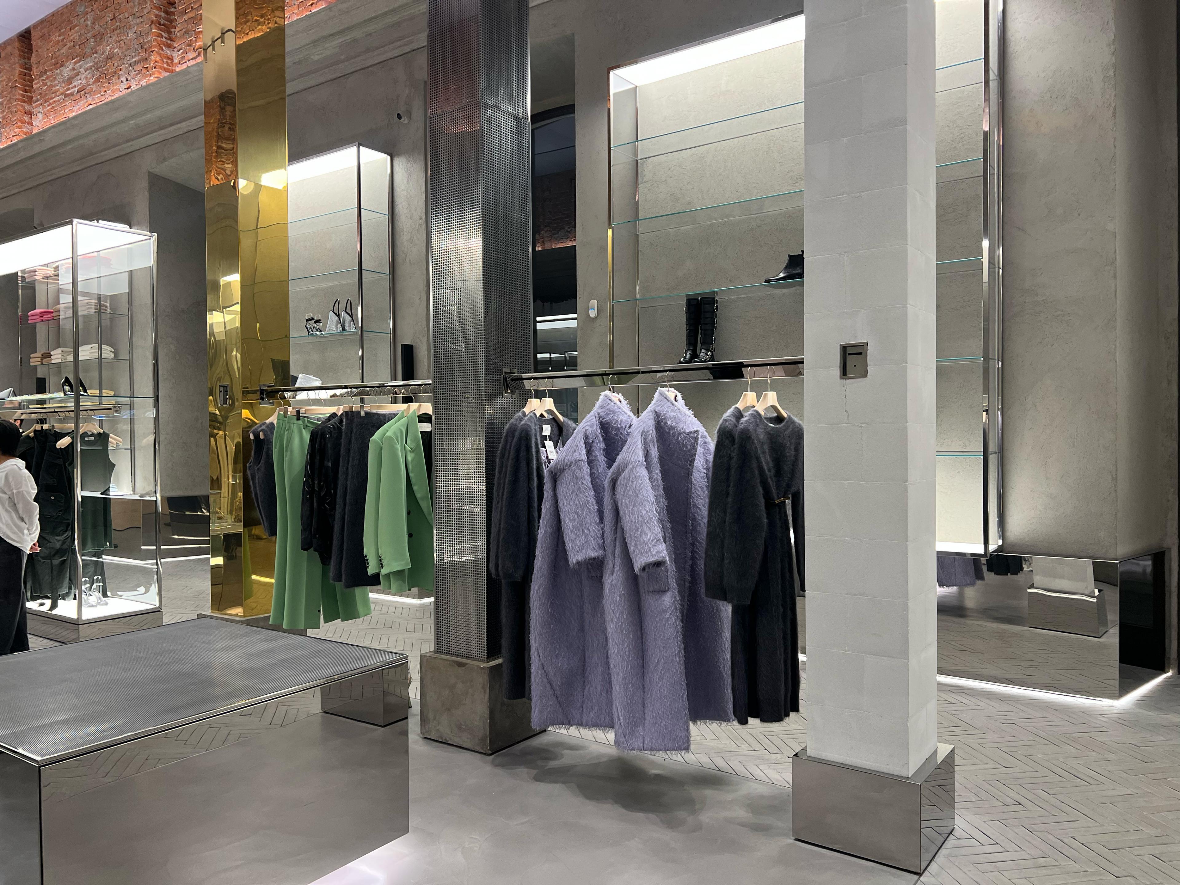 store interior with lots of mirrors and a metal rack with a purple fur coat