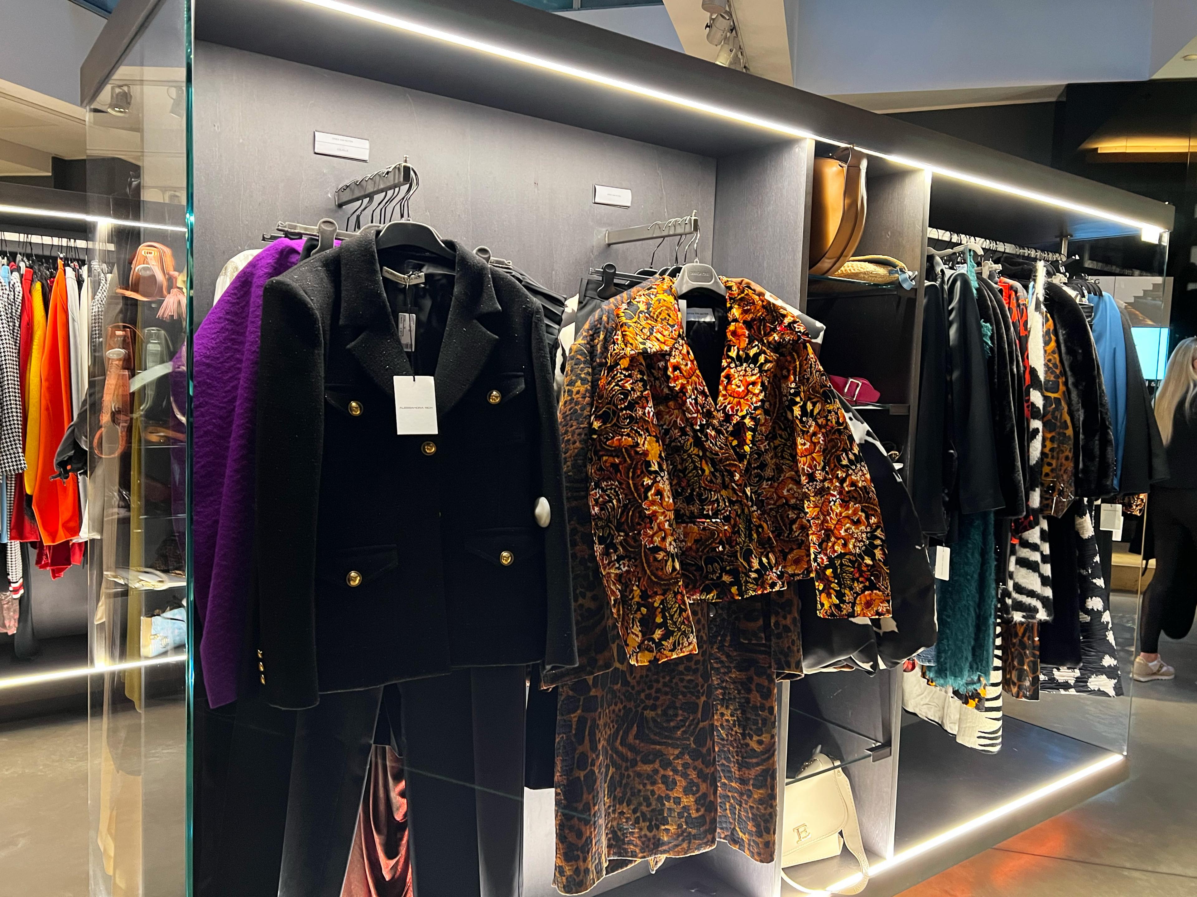 clothing store interior with vintage, colorful clothing on racks