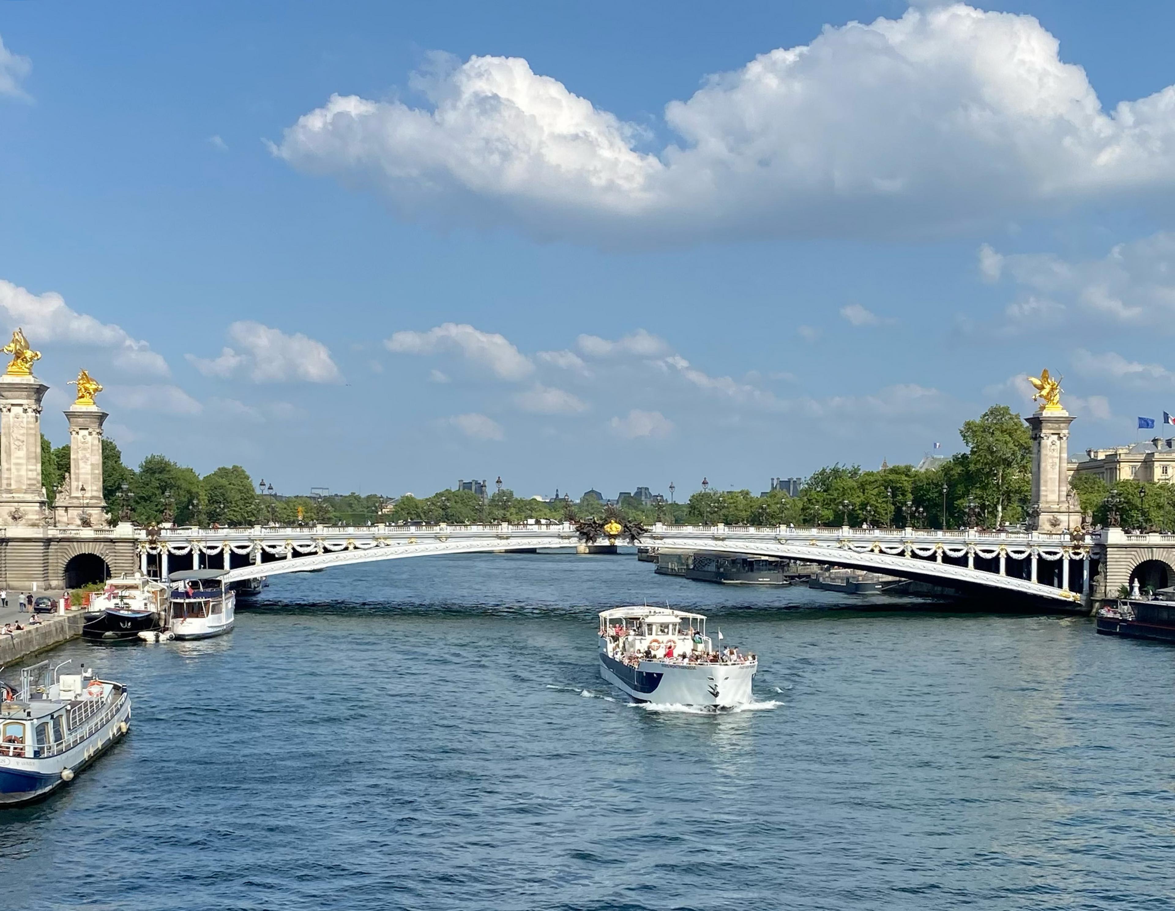 River in Paris with a bridge and an open boat