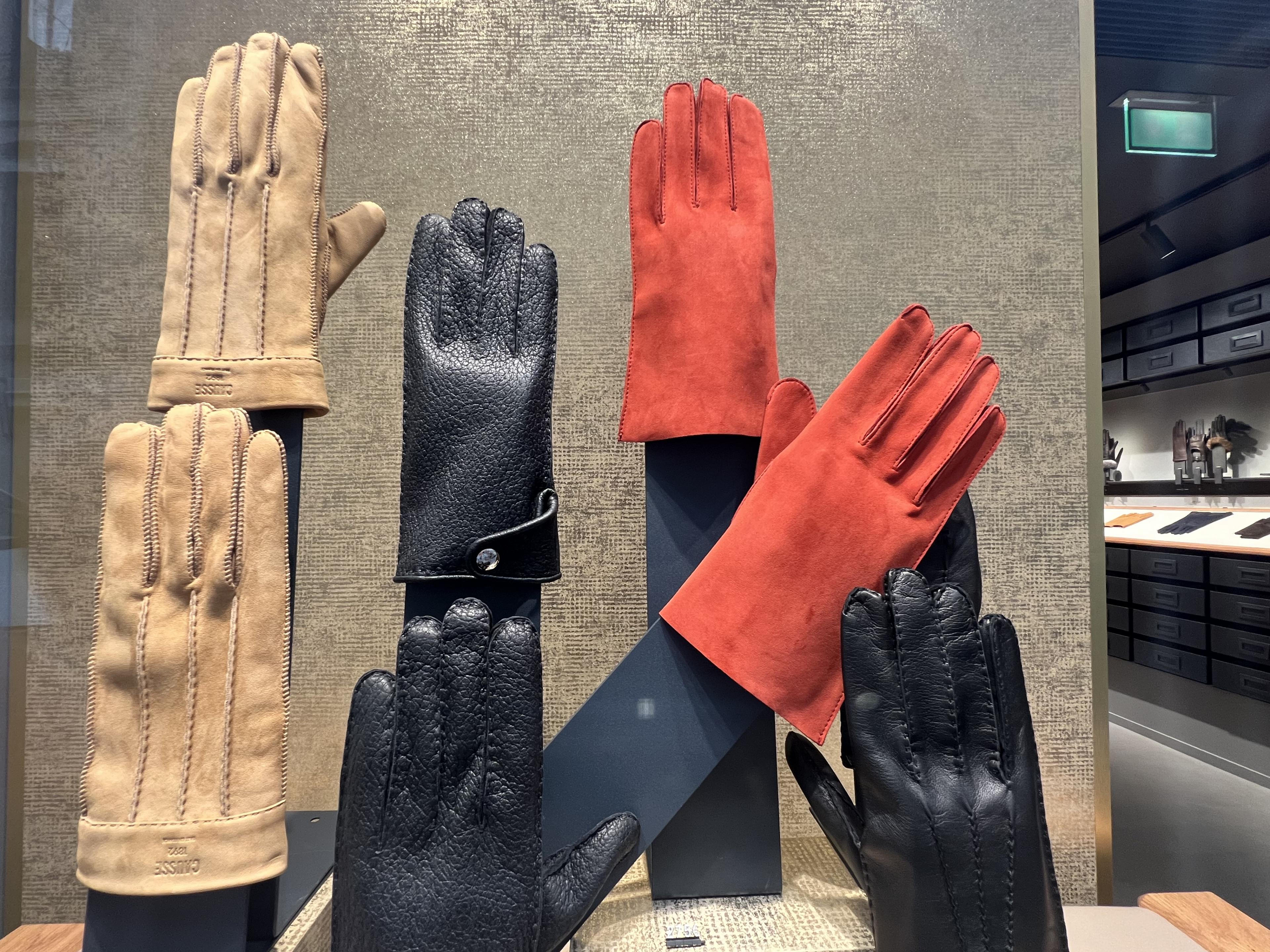 black and red leather gloves in a window