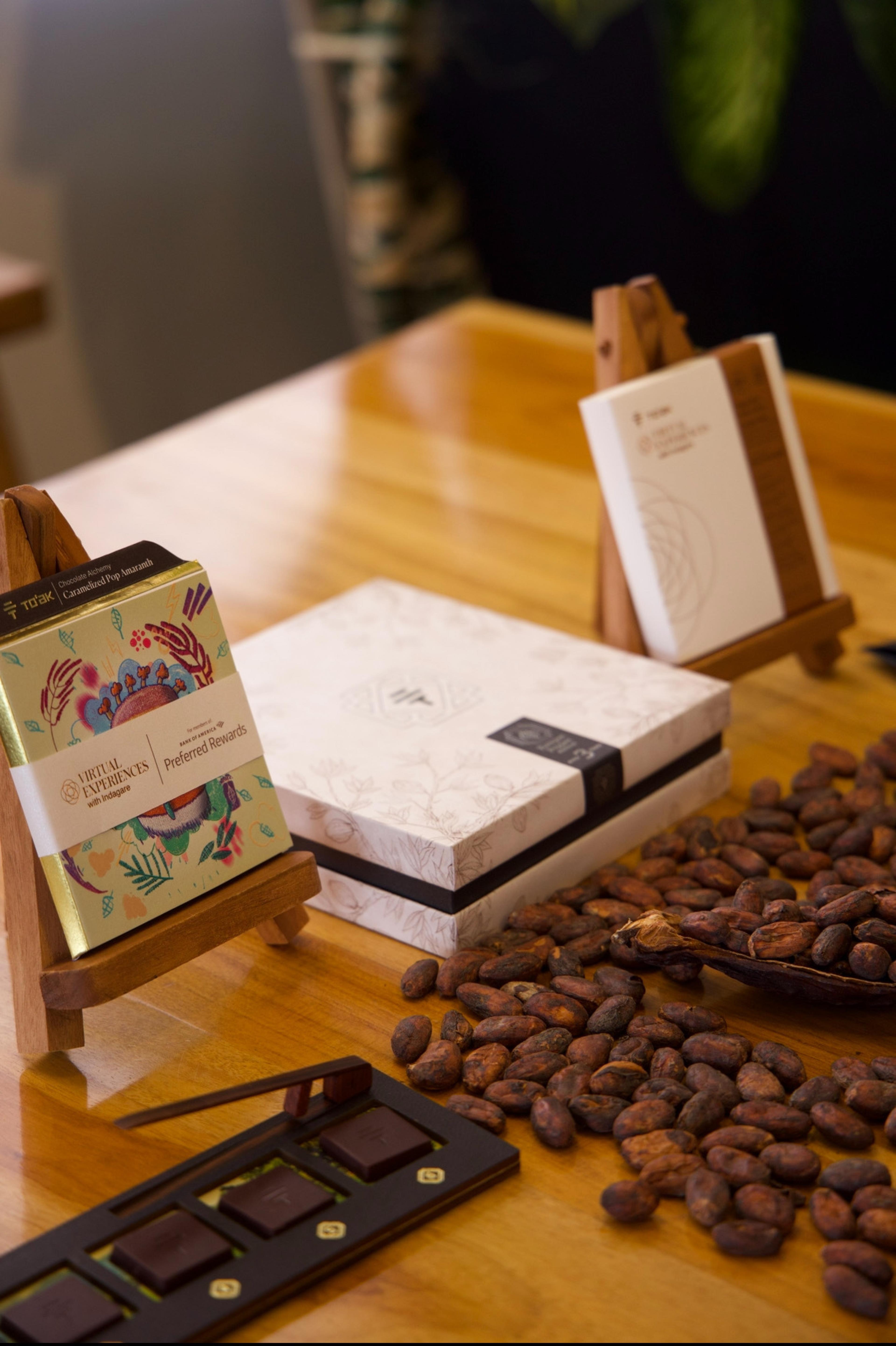 chocolate bars displayed on a mini-easel and in a box with roasted cacao beans 