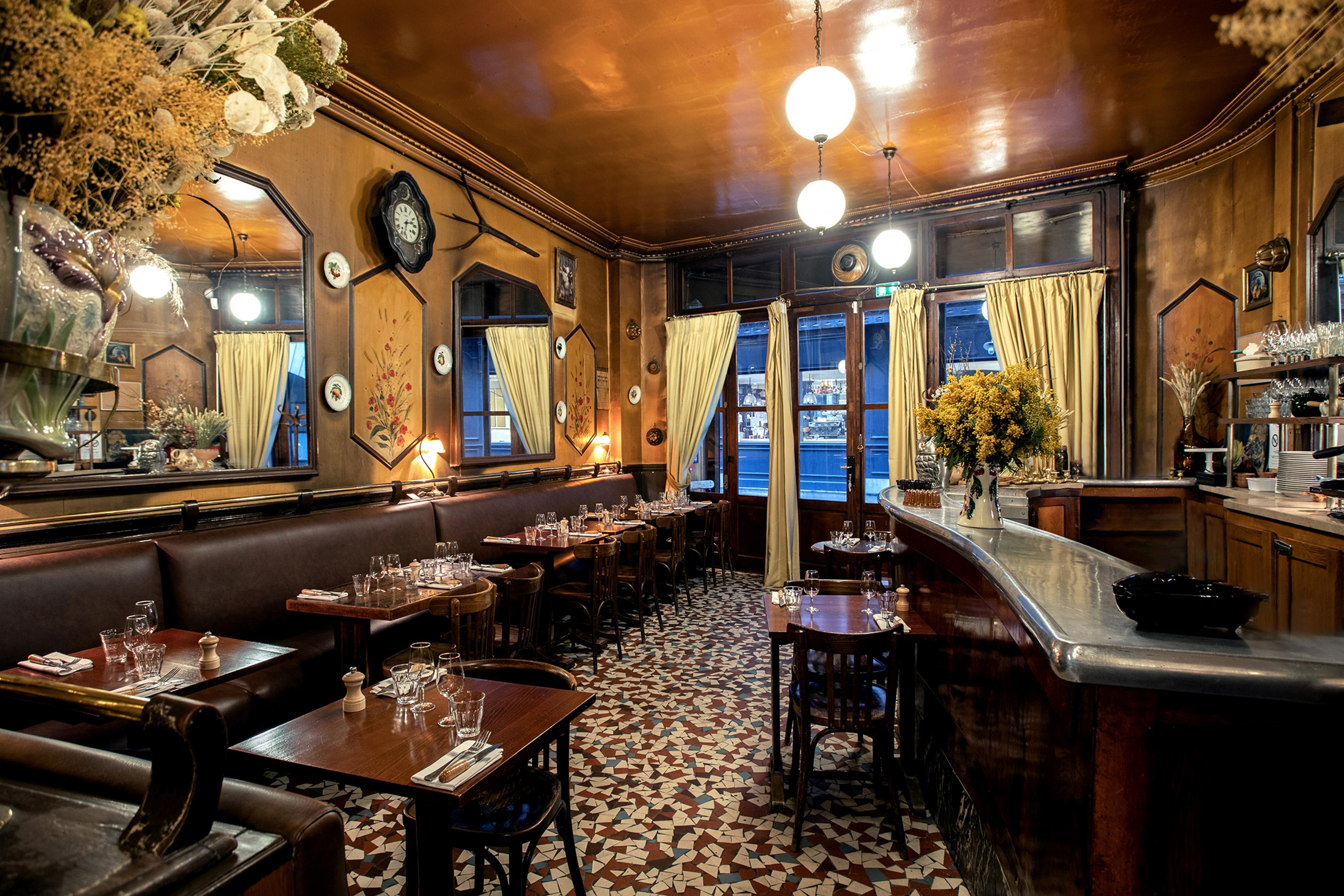 interior of paris brasserie with traditional decor and a bar