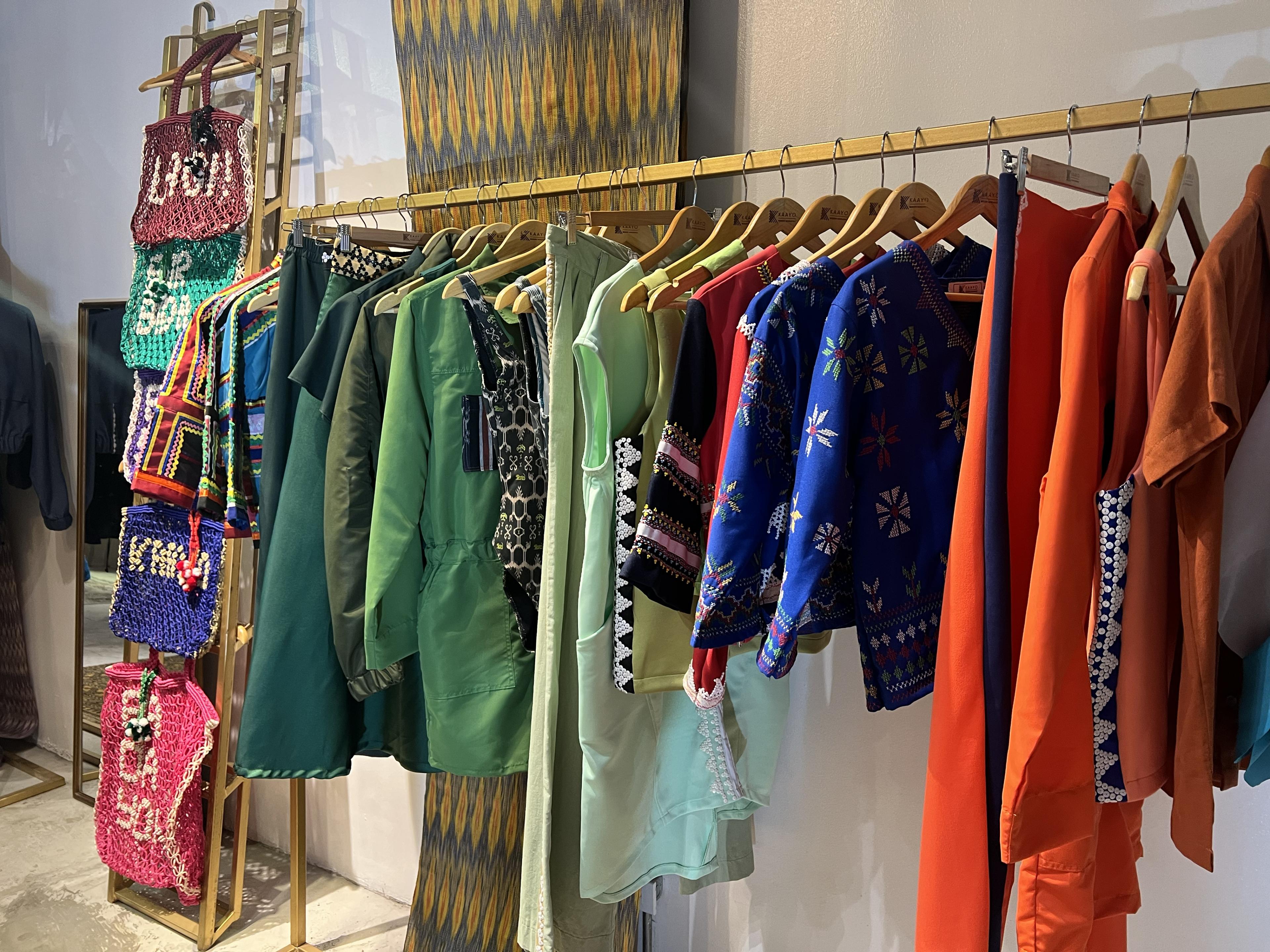 colorful women's clothing on a rack at a store