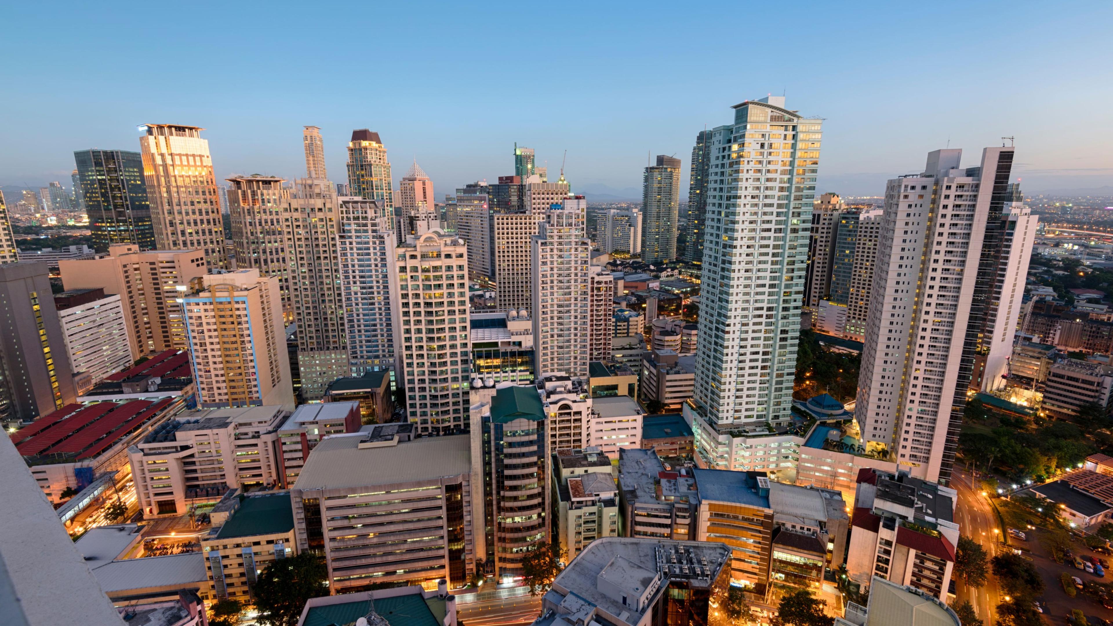 skyline view of highrises in Manila Philippines seen from the air at dusk