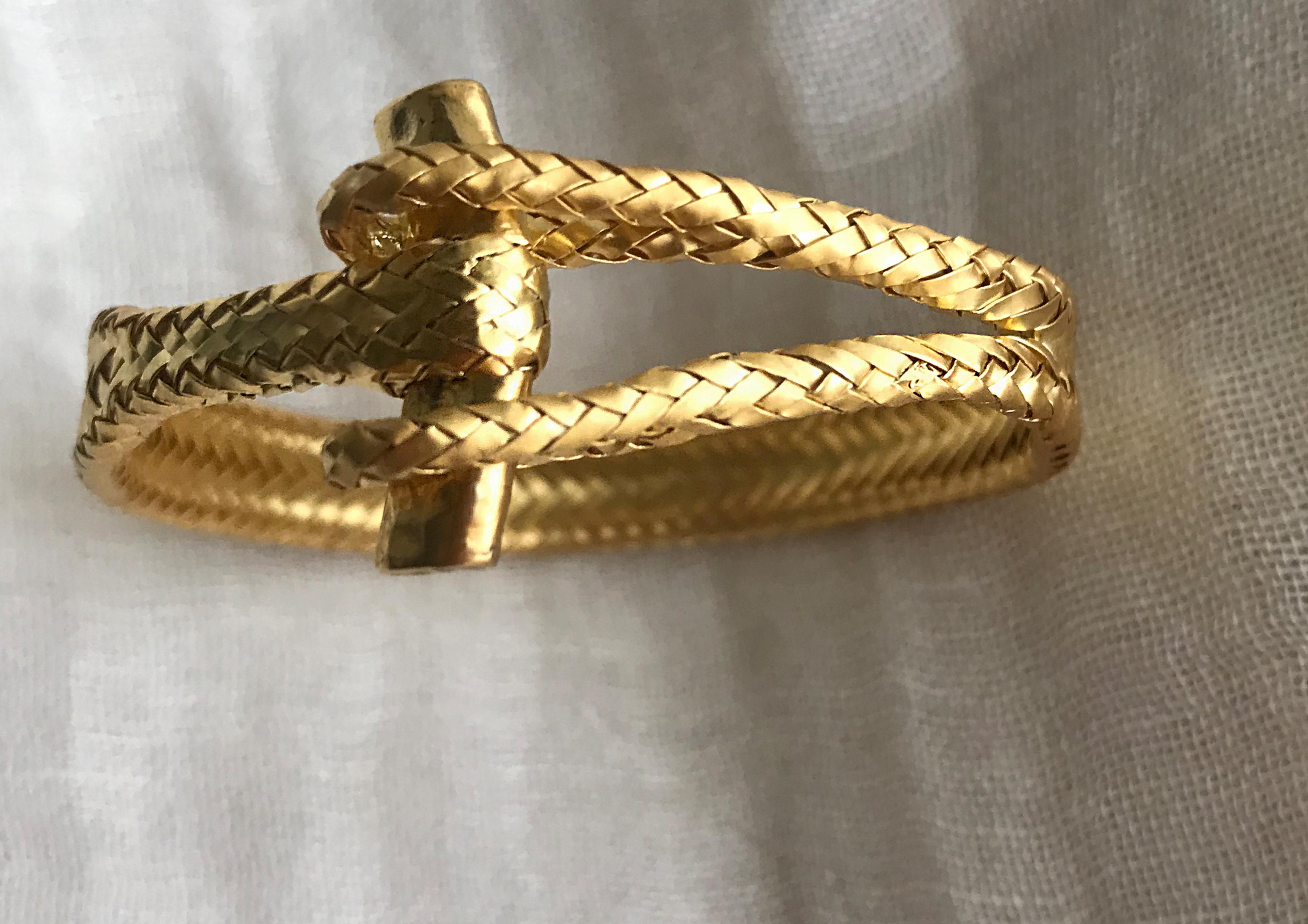 a gold bracelet with woven gold thread resembling hemp but actually made of metal