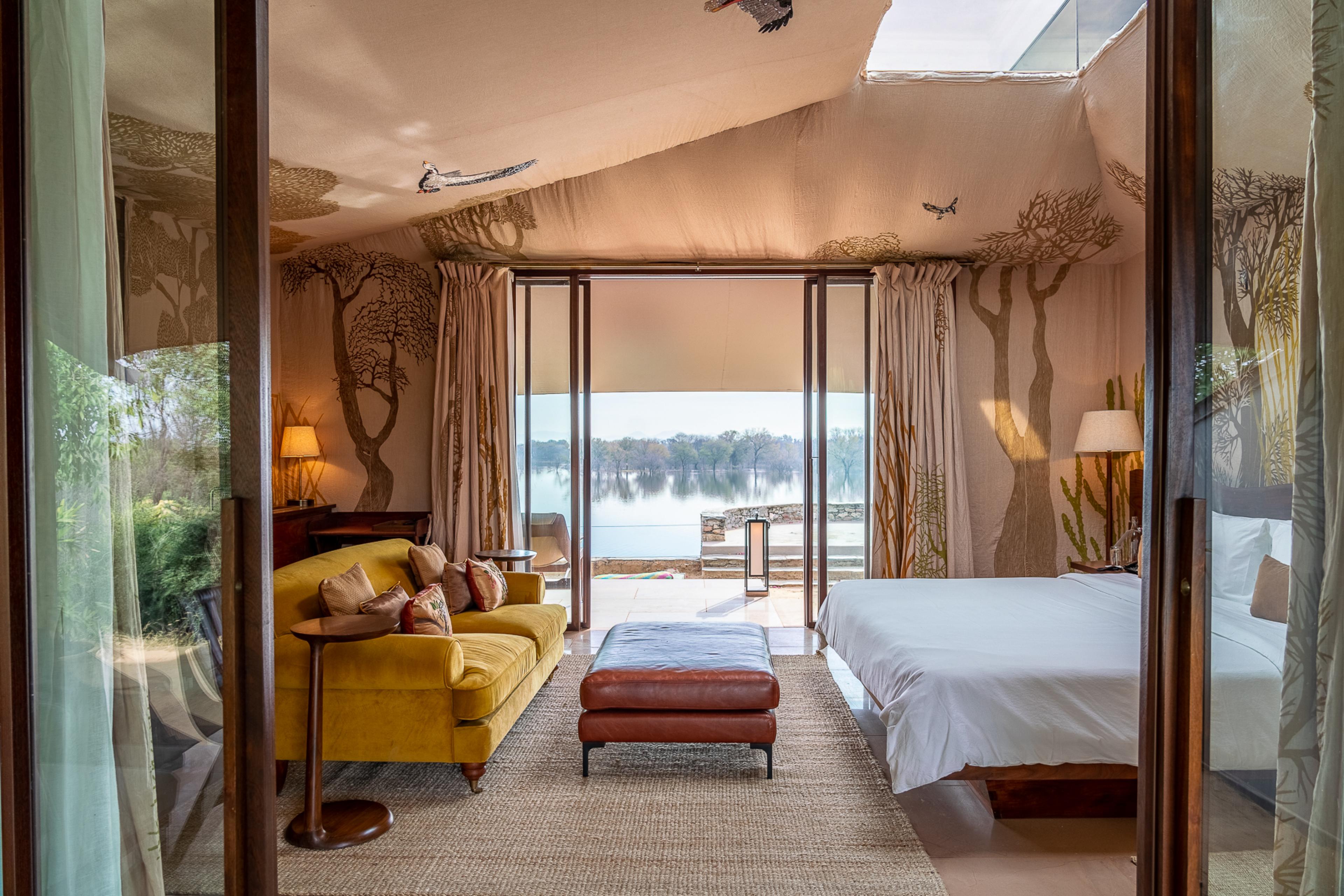 bedroom with a mustard couch overlooking a lake