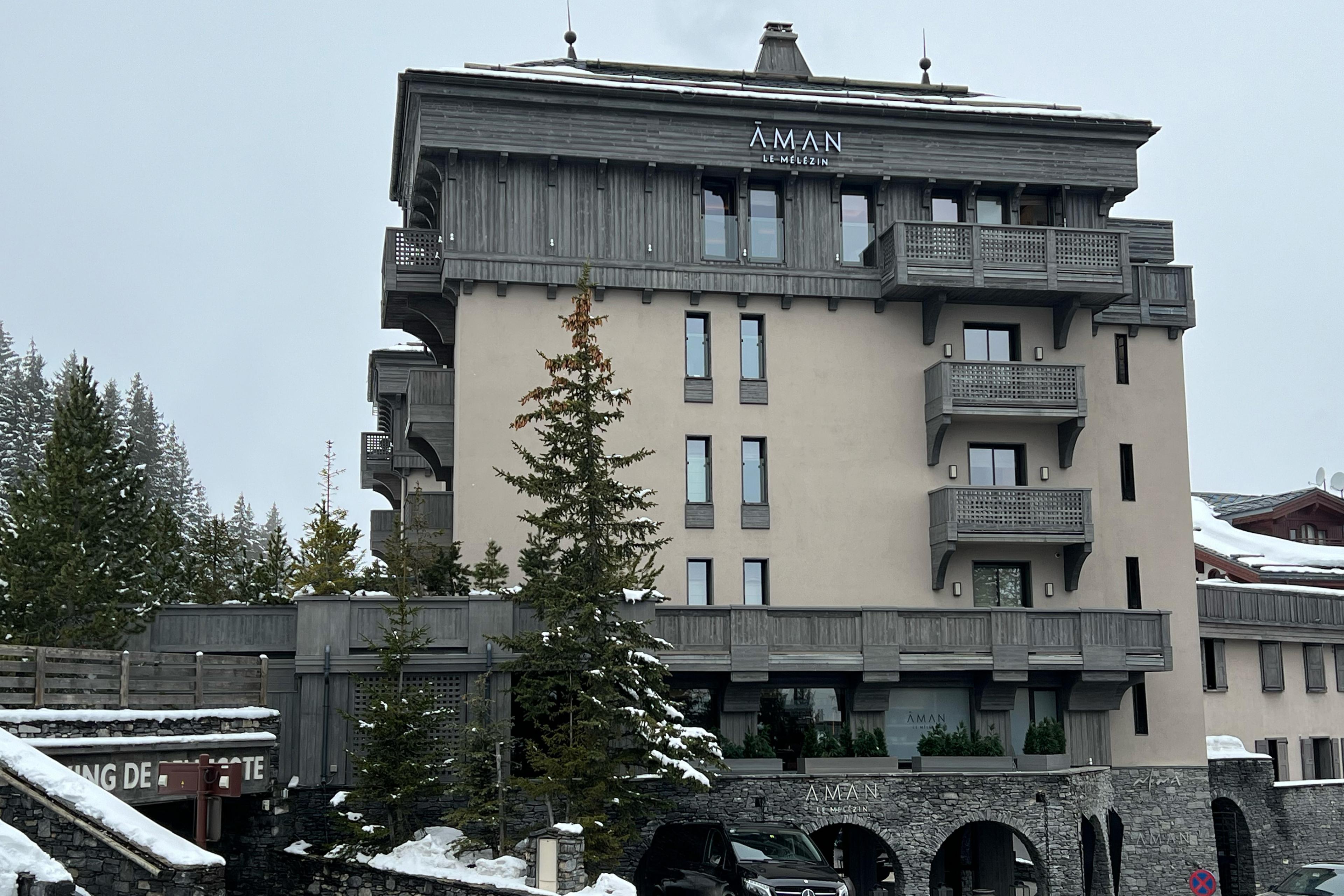 beige and gray hotel building near a forest