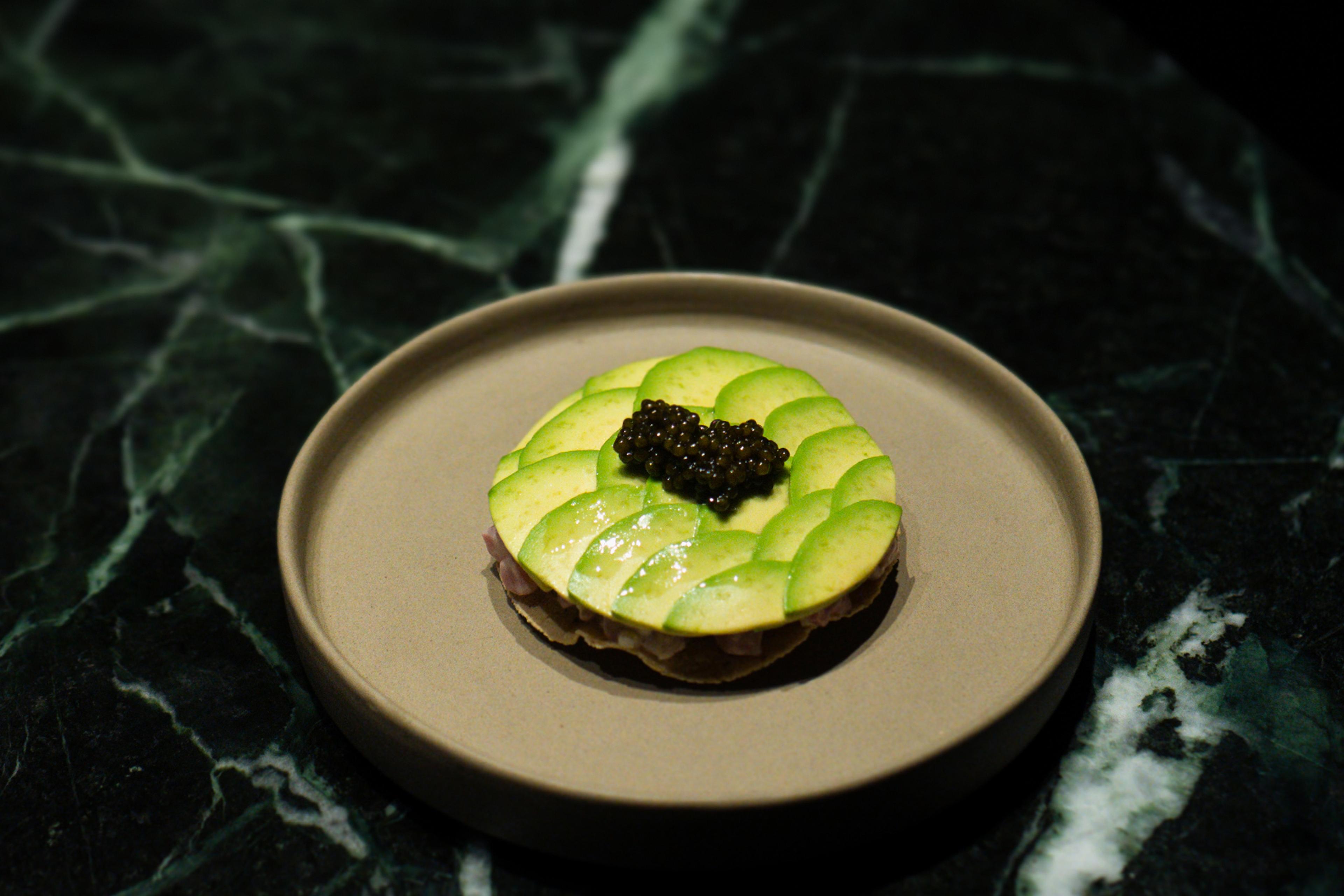 round meal with avocado slices and caviar