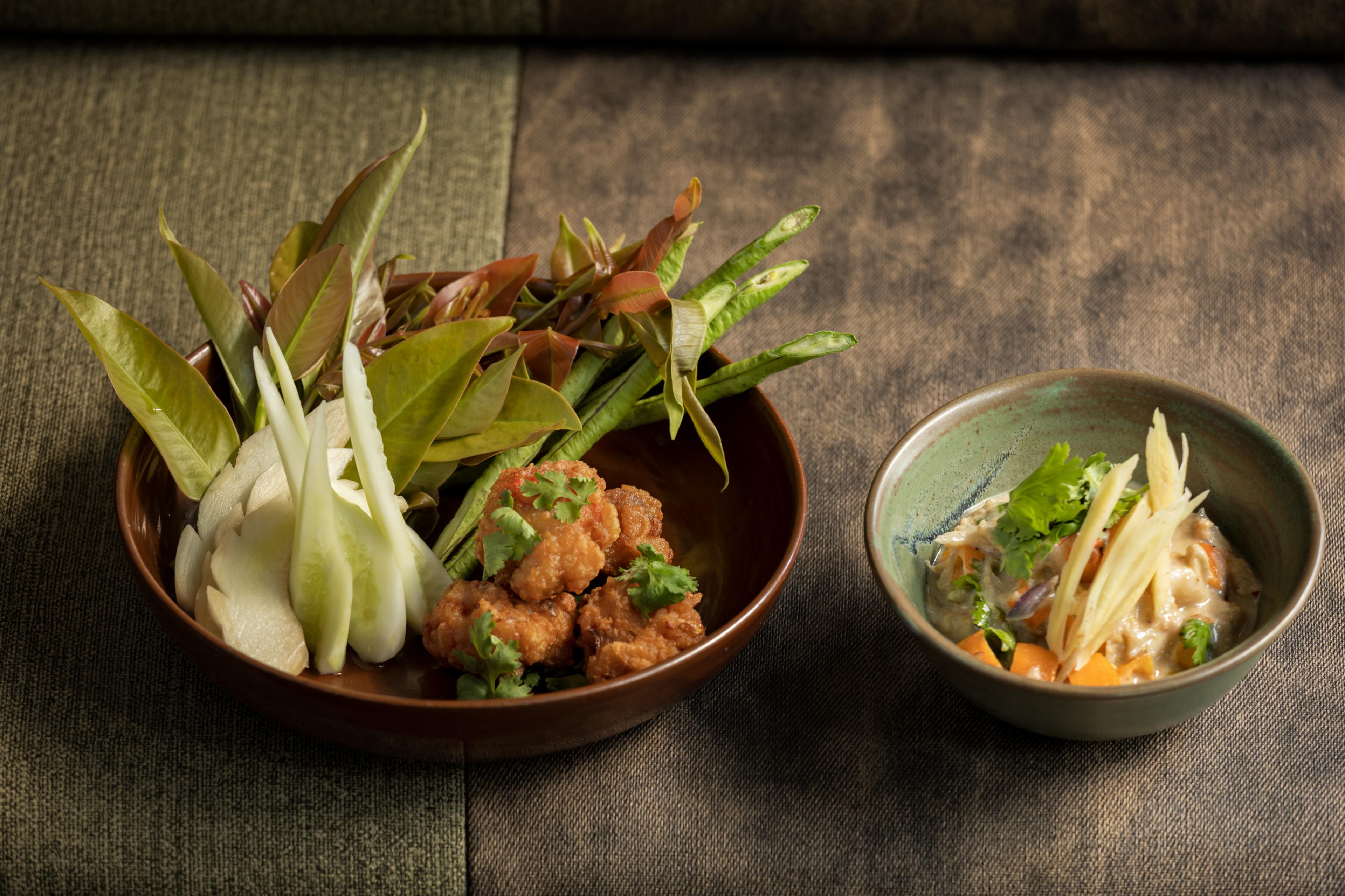 two bowls with vegetable focused thai dishes