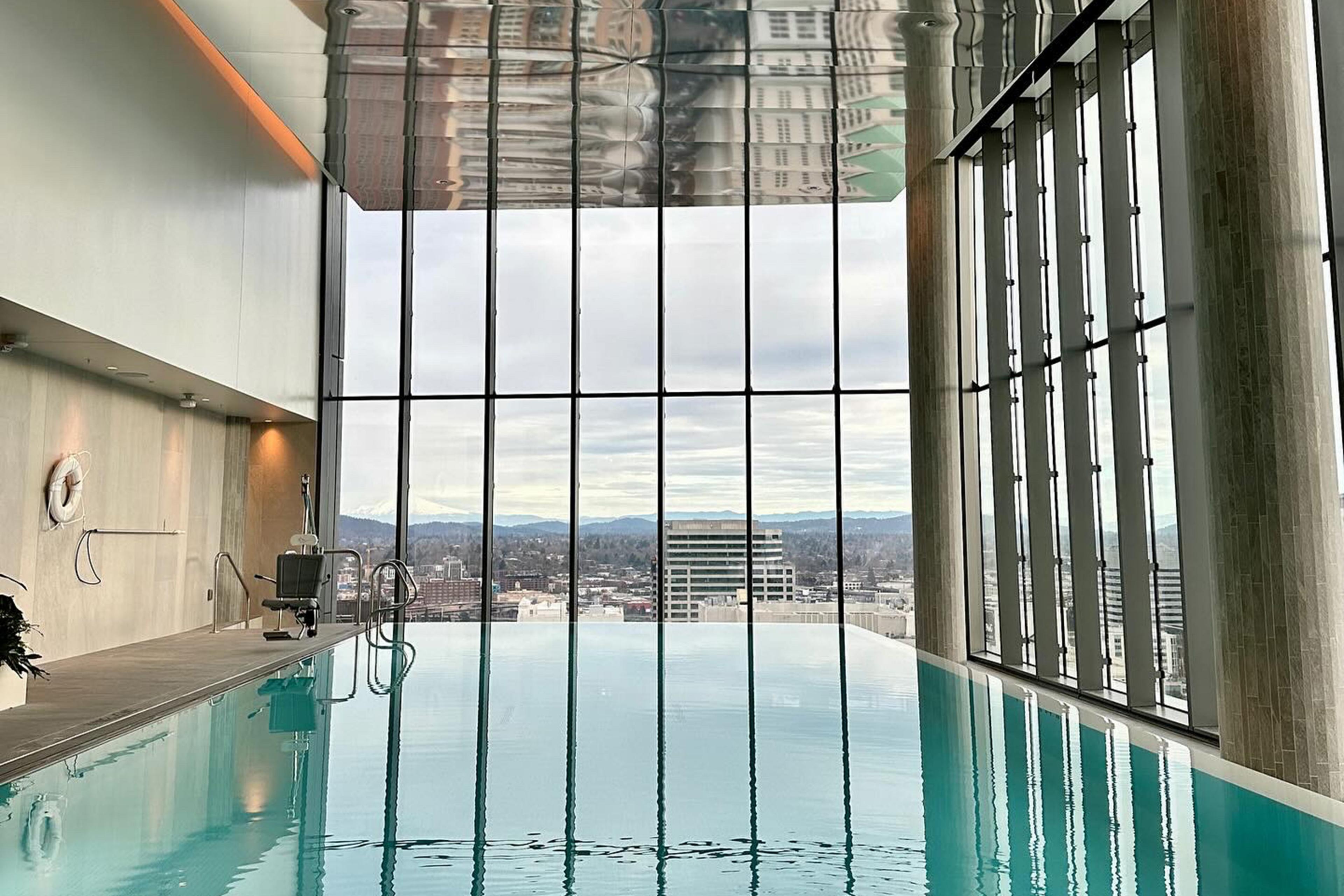 pool with high ceiling and floor to ceiling windows