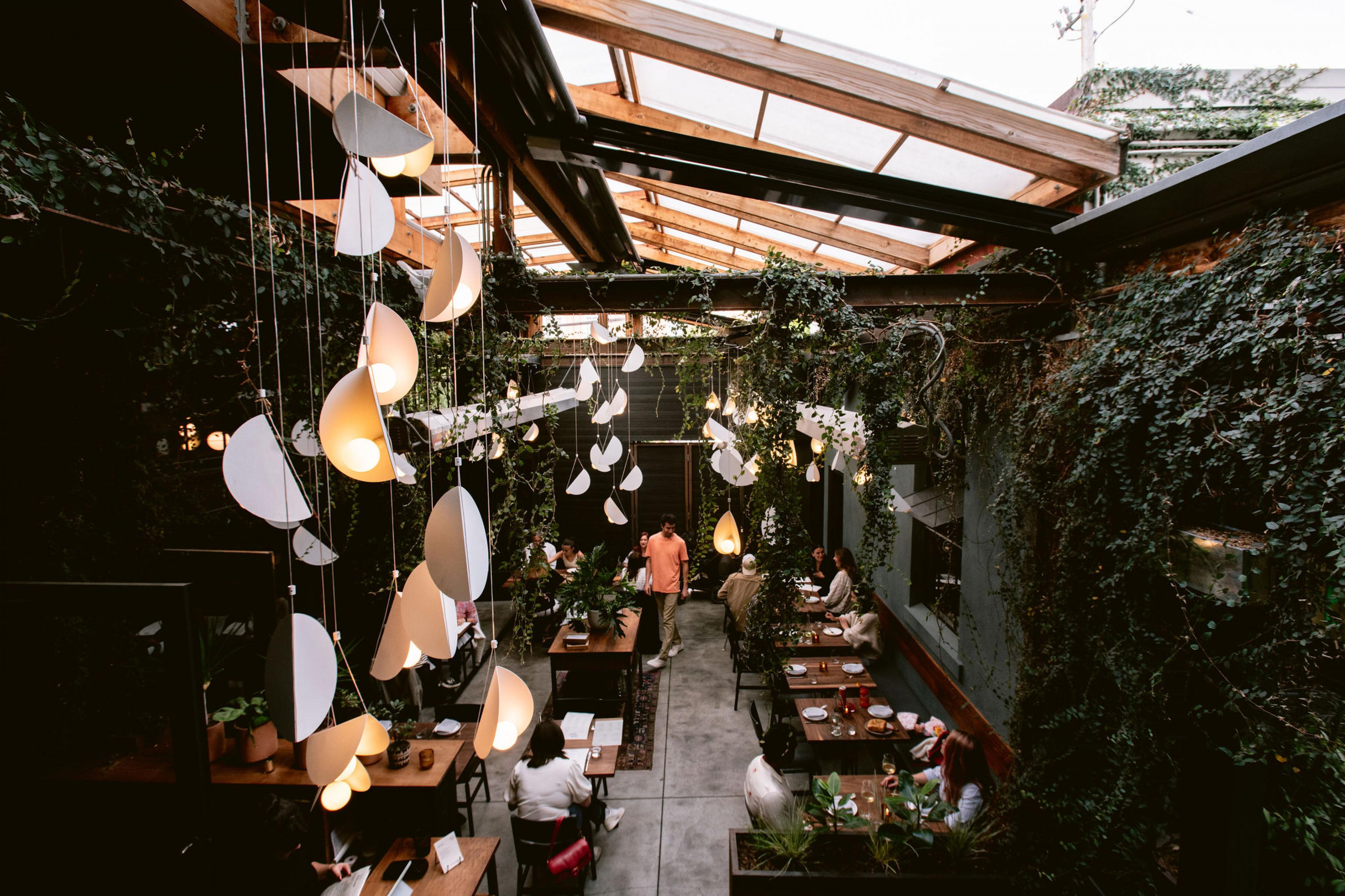restaurant interior that looks like a courtyard with greenery