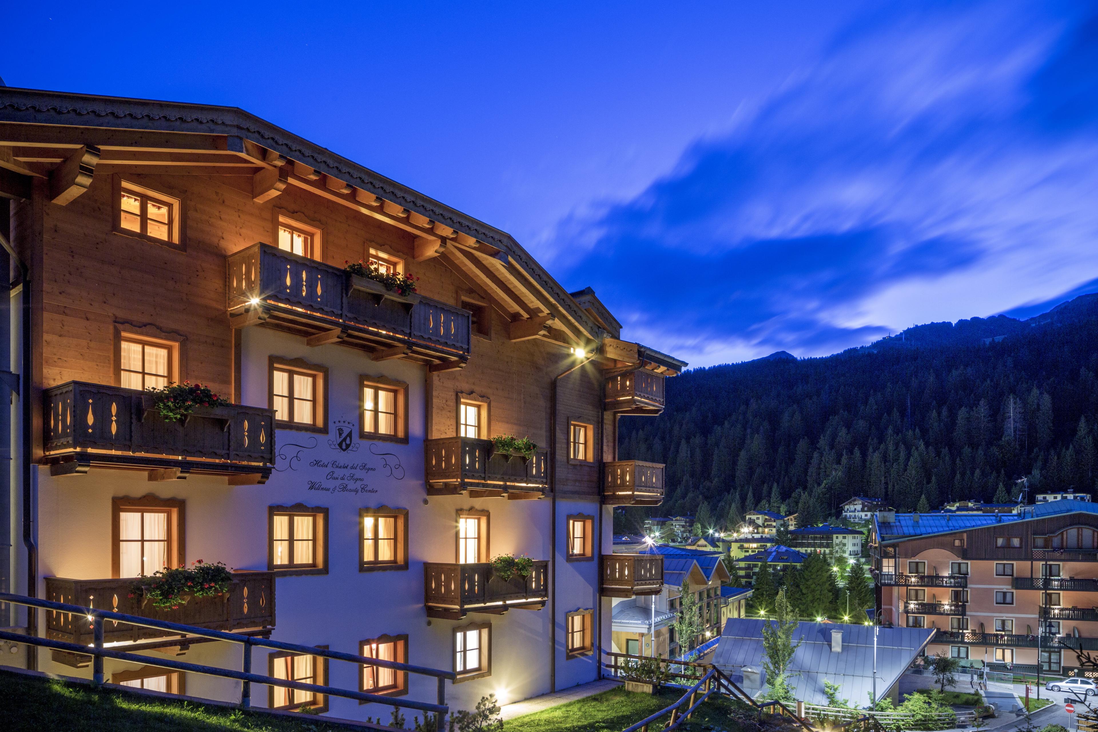 Exterior of hotel and dolomites mountains