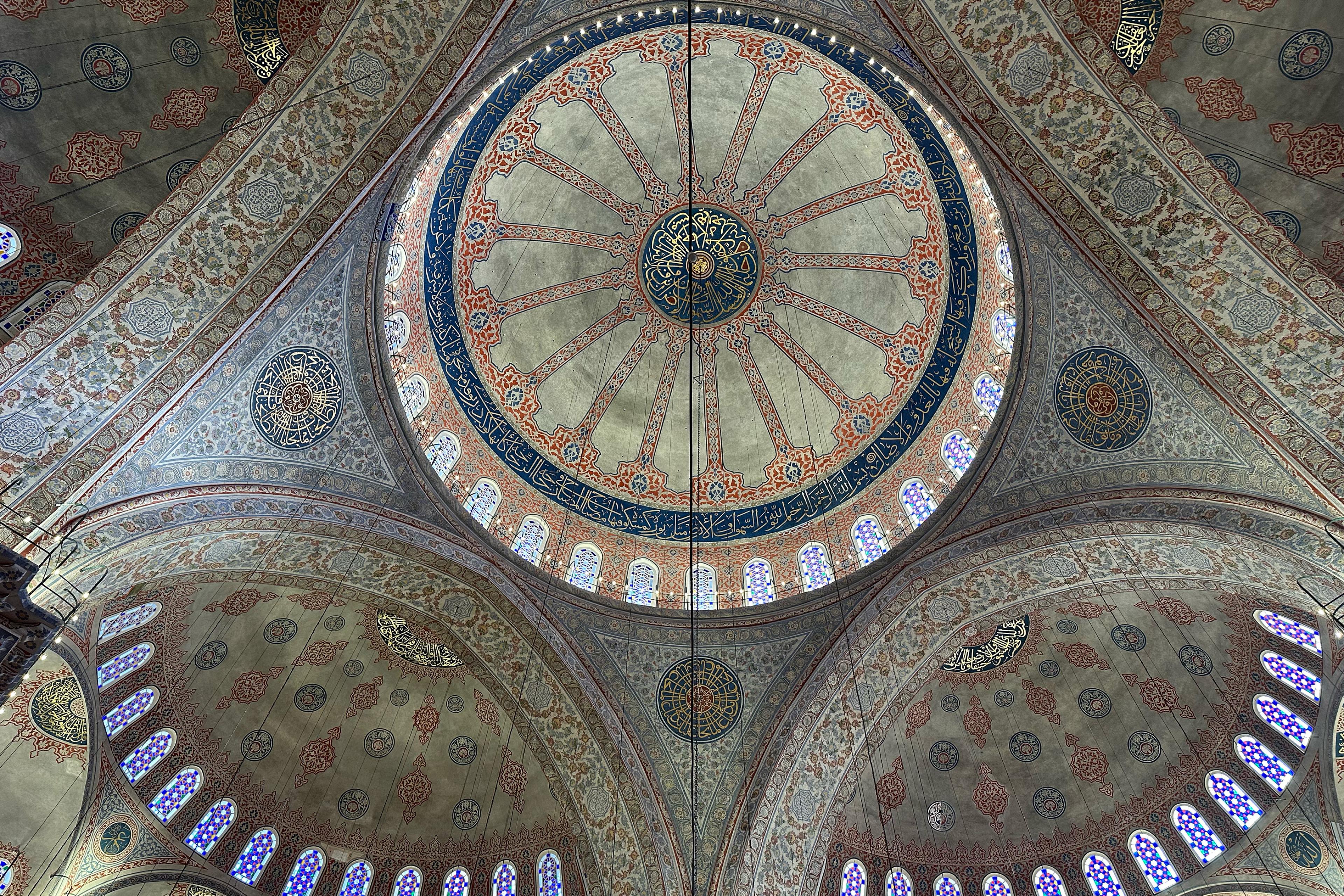 intricately painted domed mosque ceiling