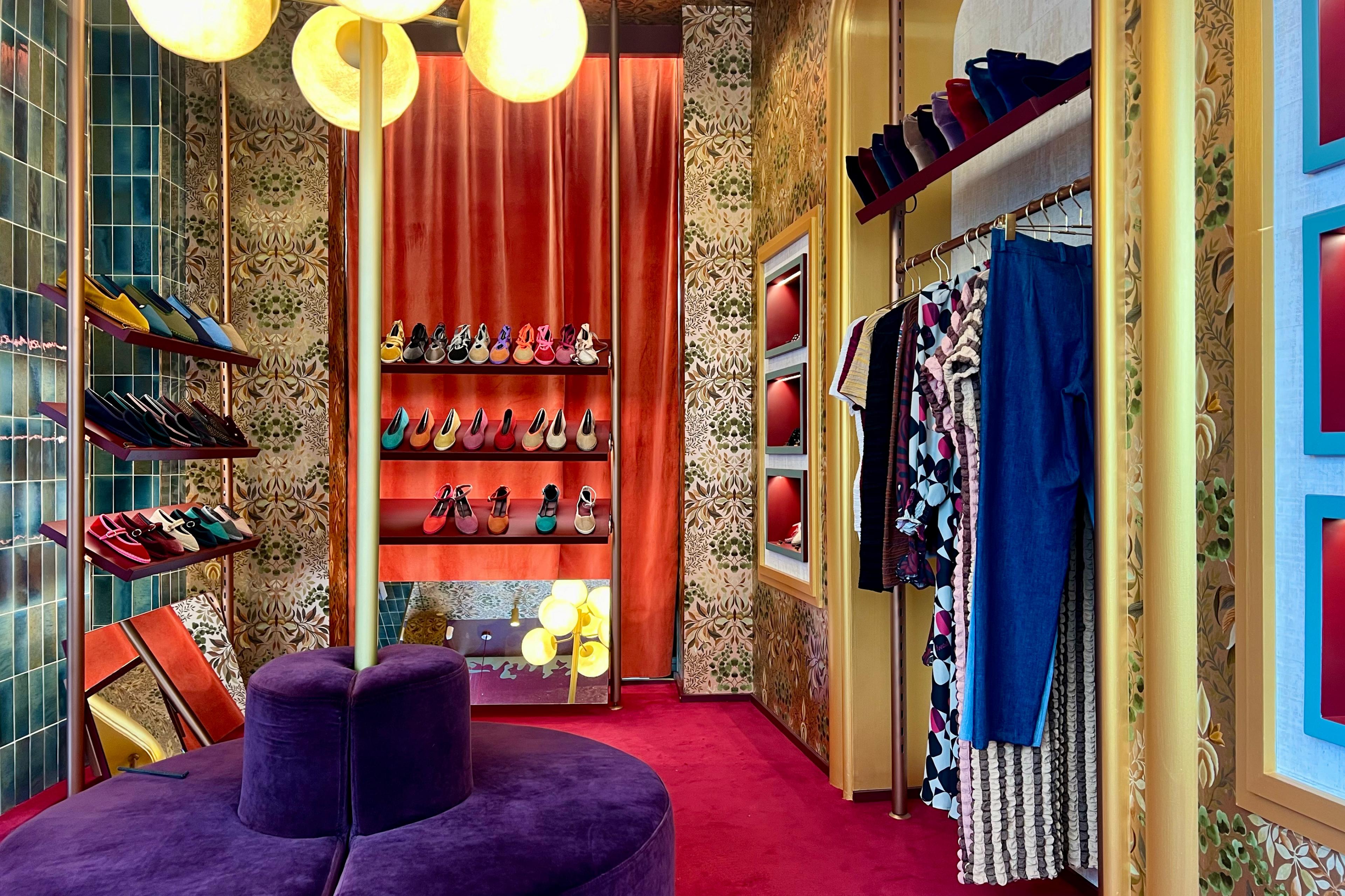 colorful boutique with shoes and clothes and a purple cushion