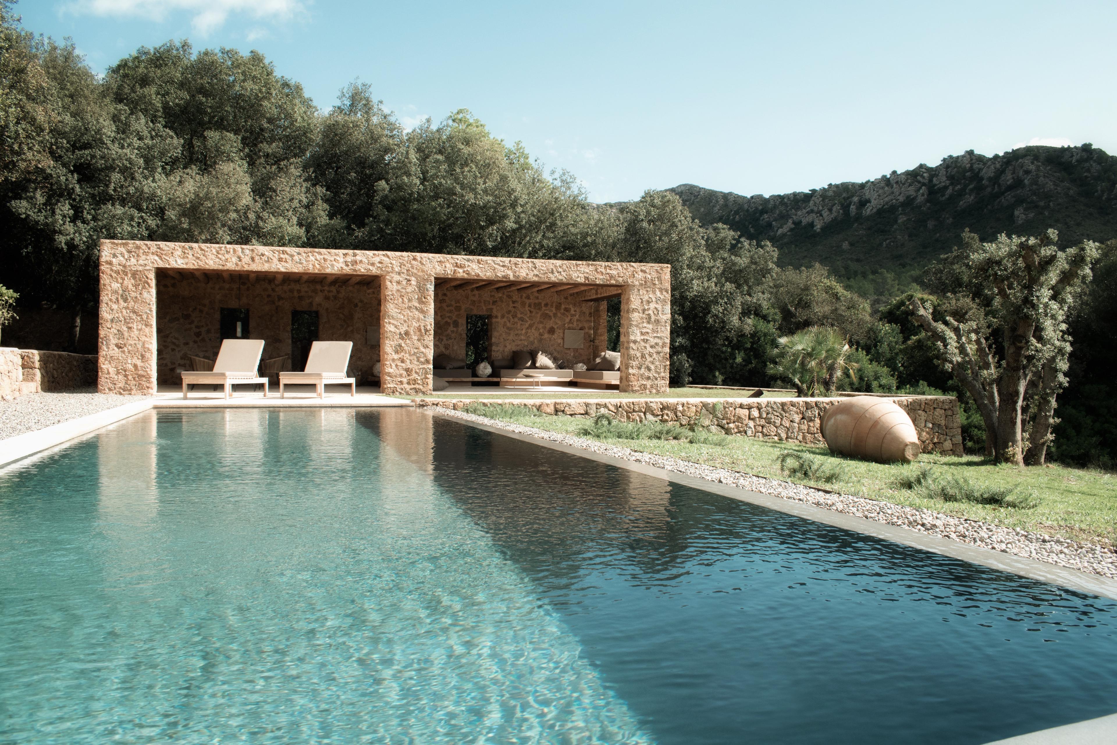 private rectangular pool with a stone cover over the daybeds