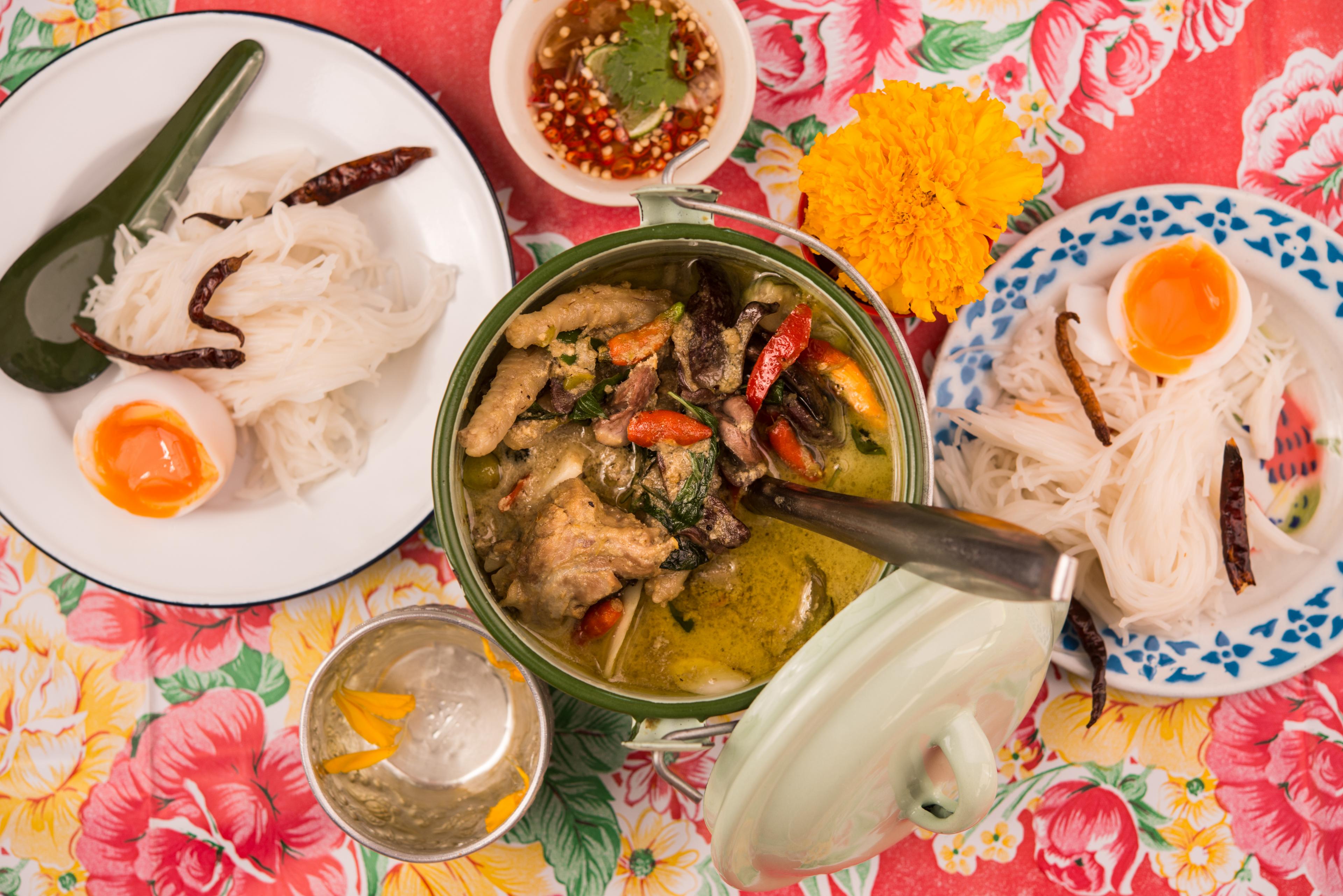colorful table with plates of thai food
