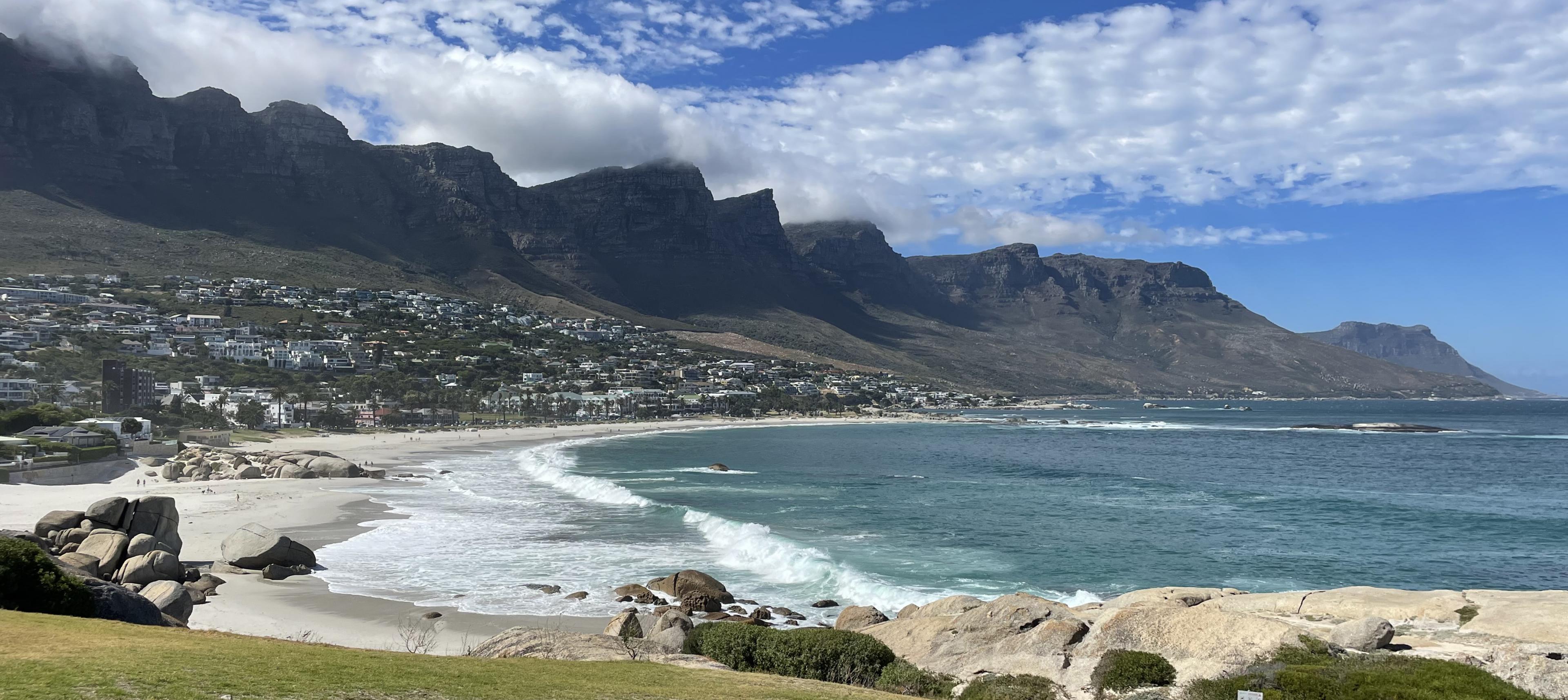 view of city of cape town coastline with table mountain on left and ocean on right