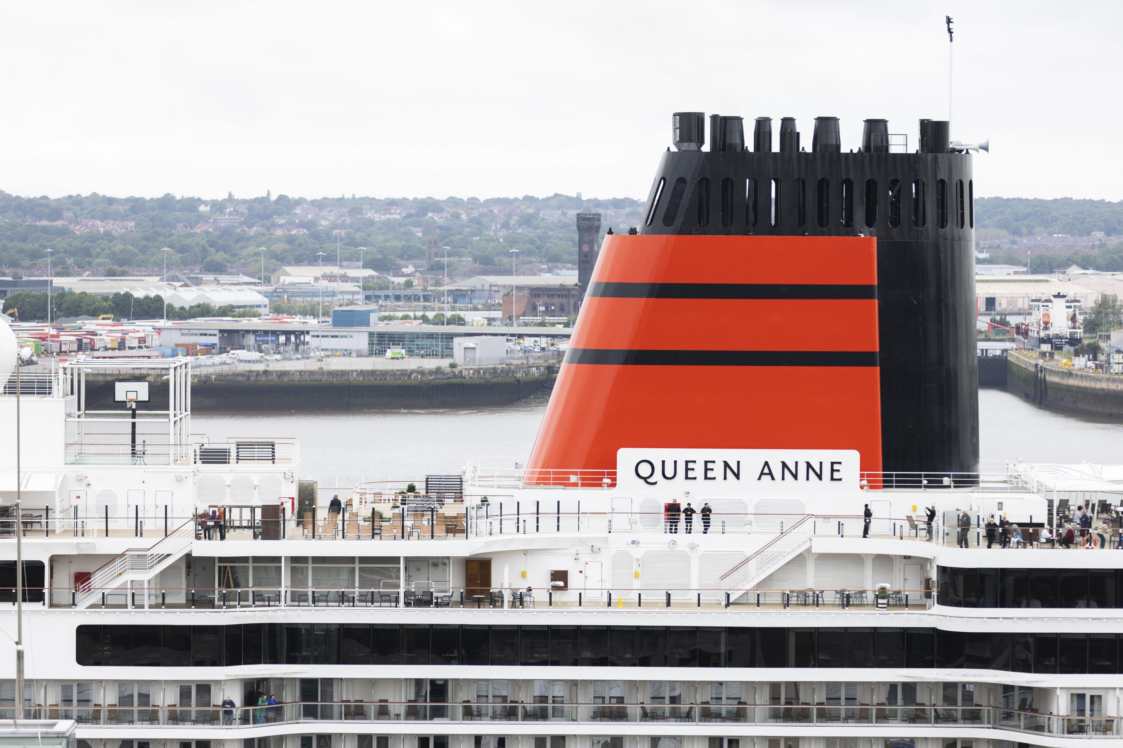 top decks and red funnel of an ocean liner. funnel says queen anne on it