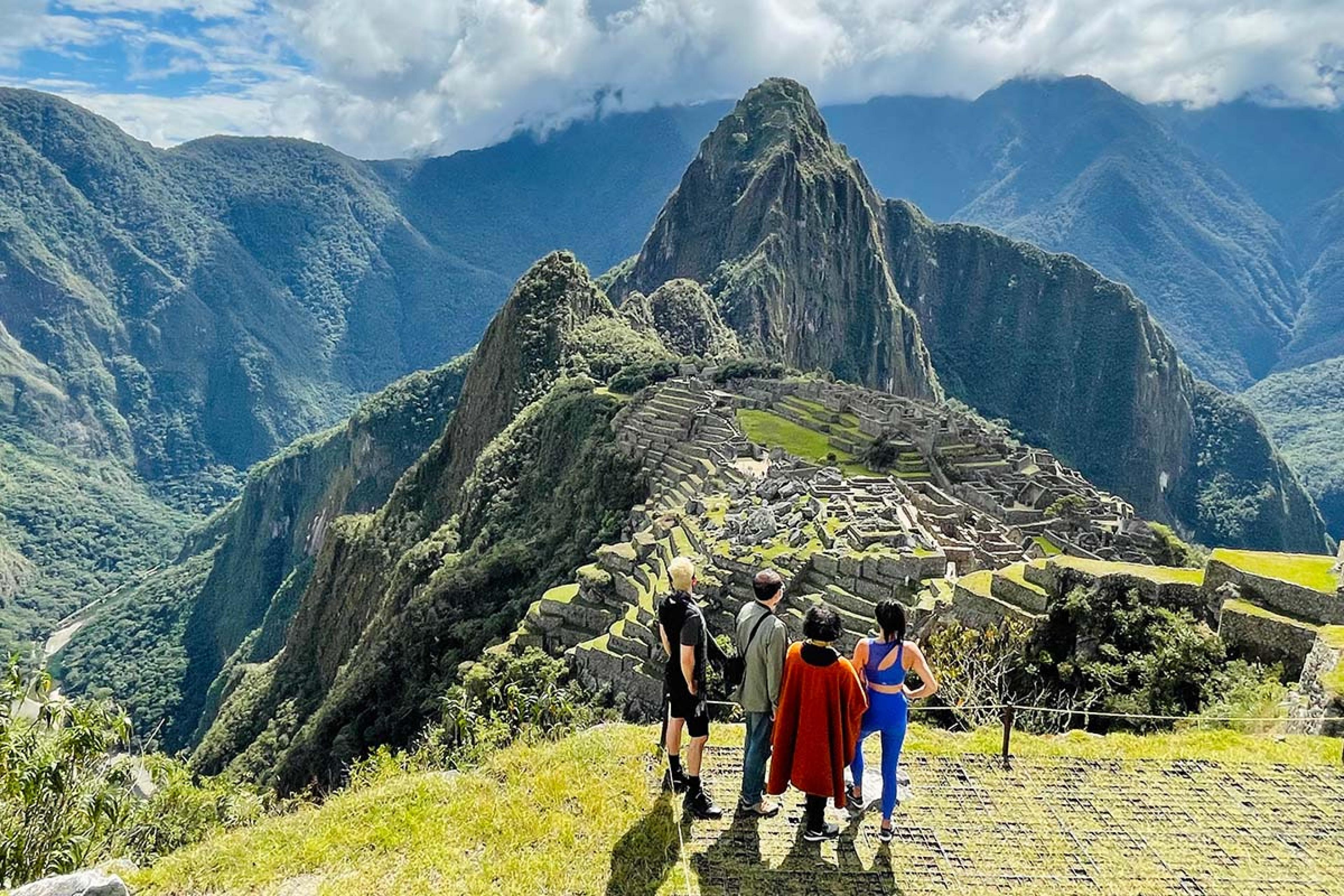 four people overlooking Machu Piccu
