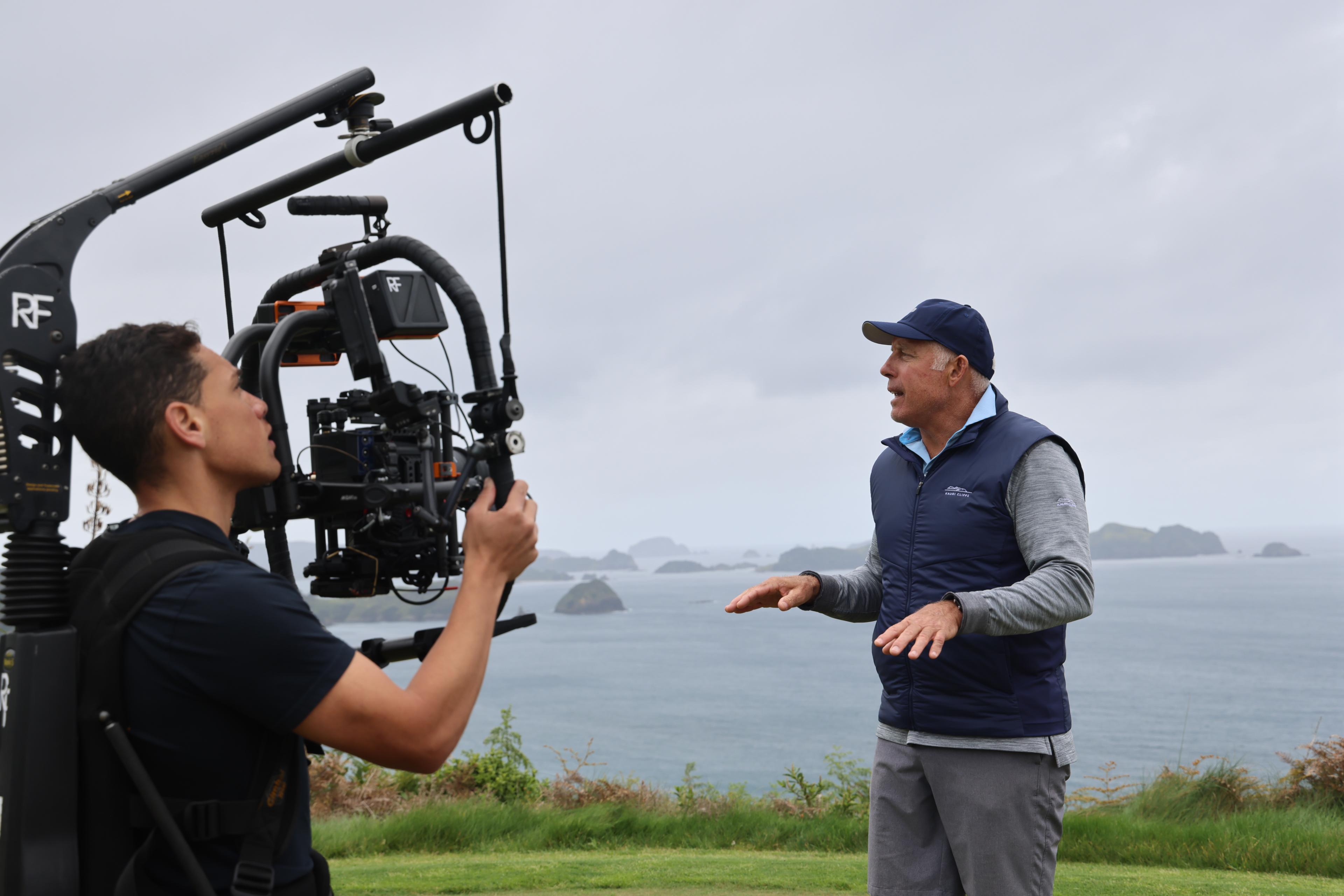 Steve Williams and a camera man with a view of water from the golf course