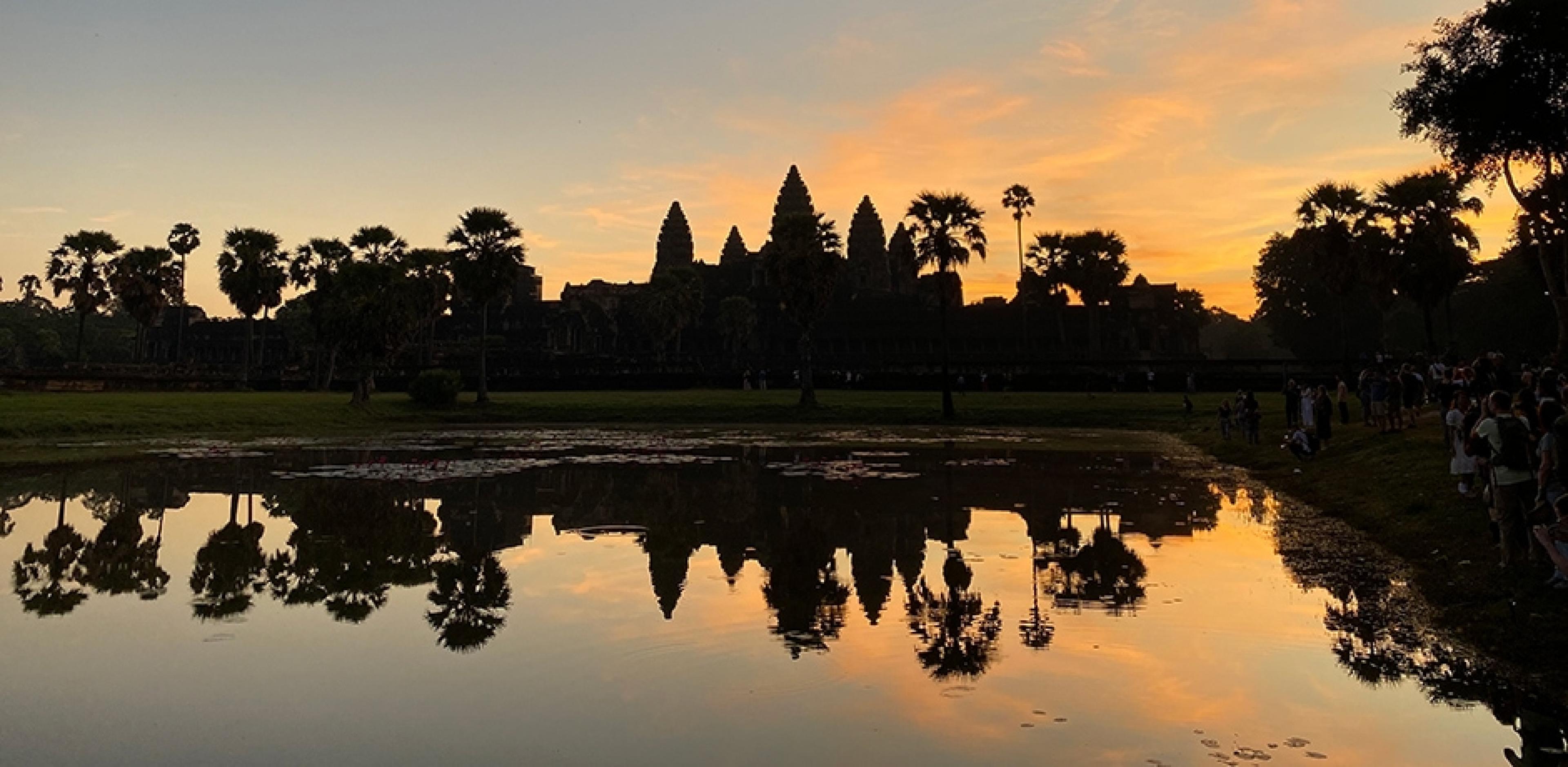 sunset making a silhouette of ancient temples at Angkor Wat