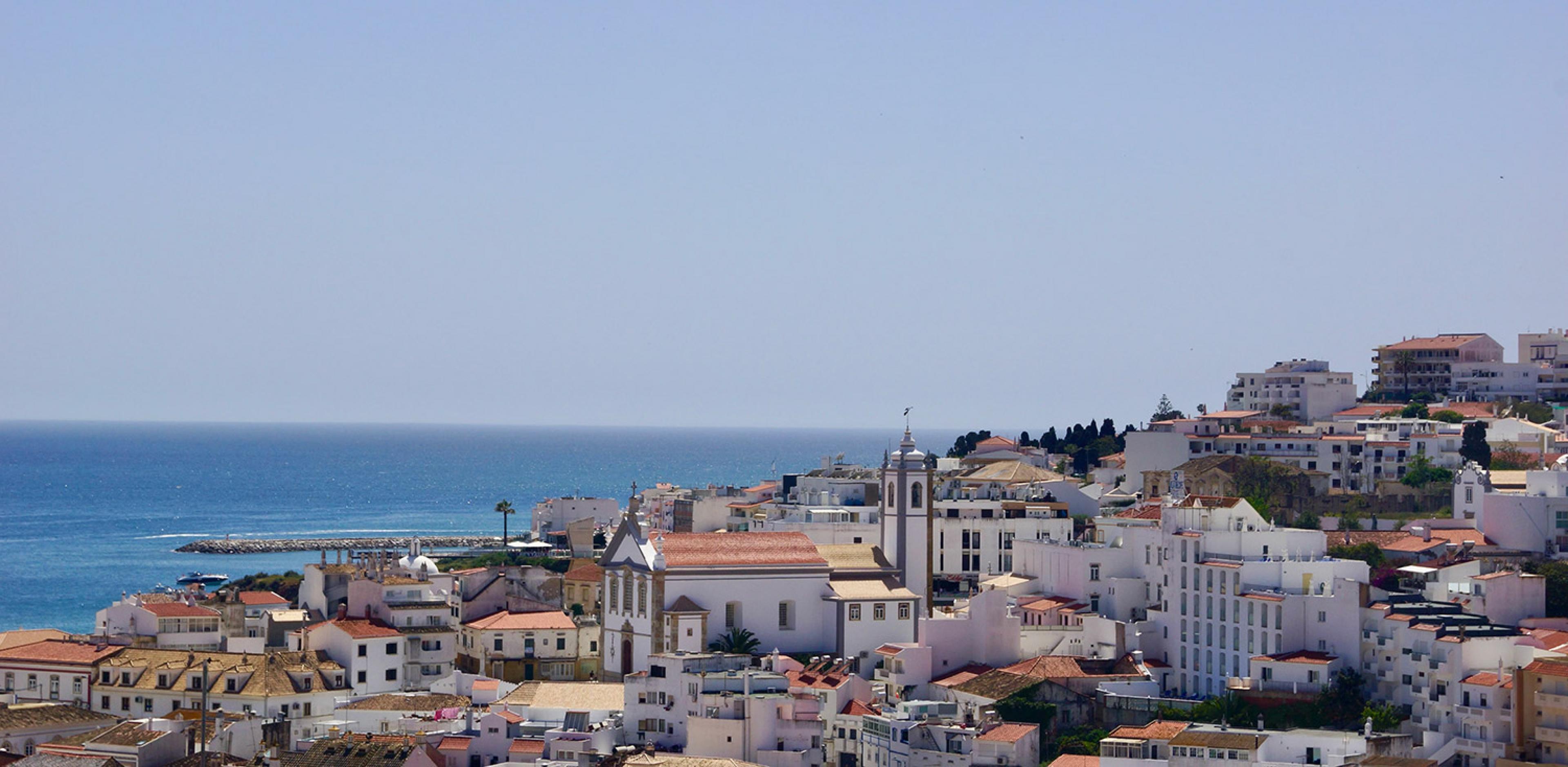 view over Albufiera portugal with white buildings and atlantic ocean