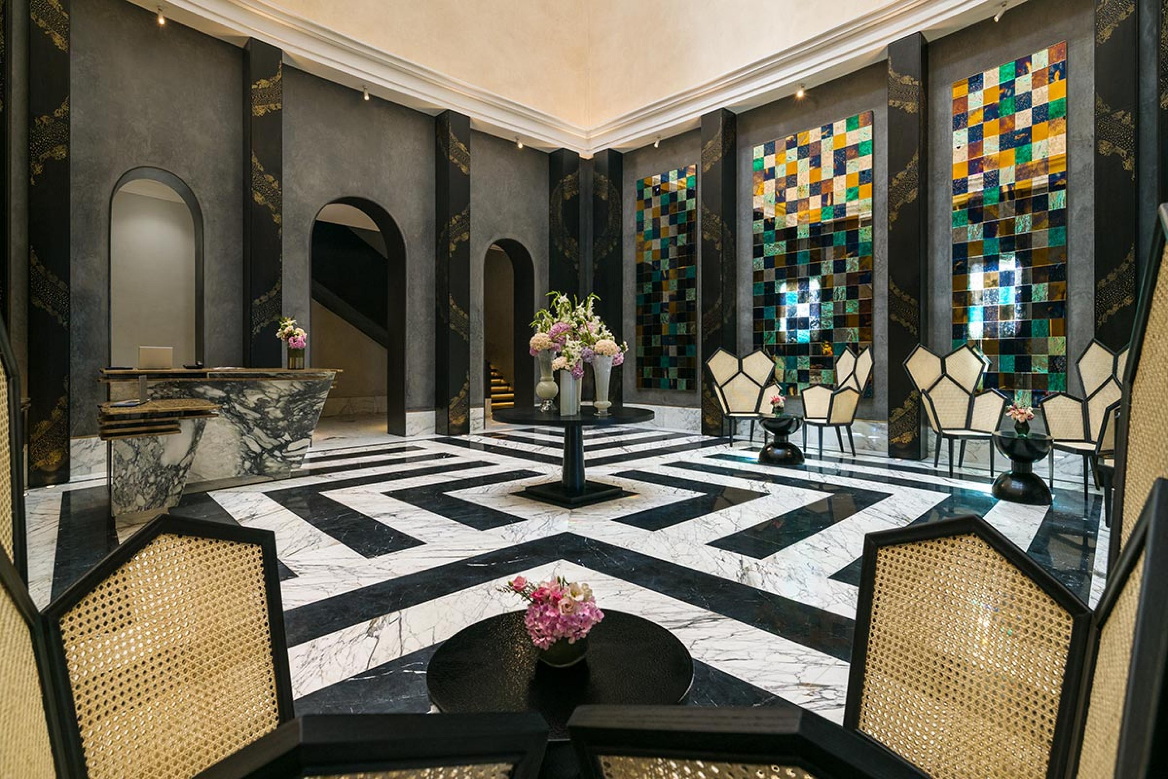 grand moroccan hotel lobby with black and white stone floor 