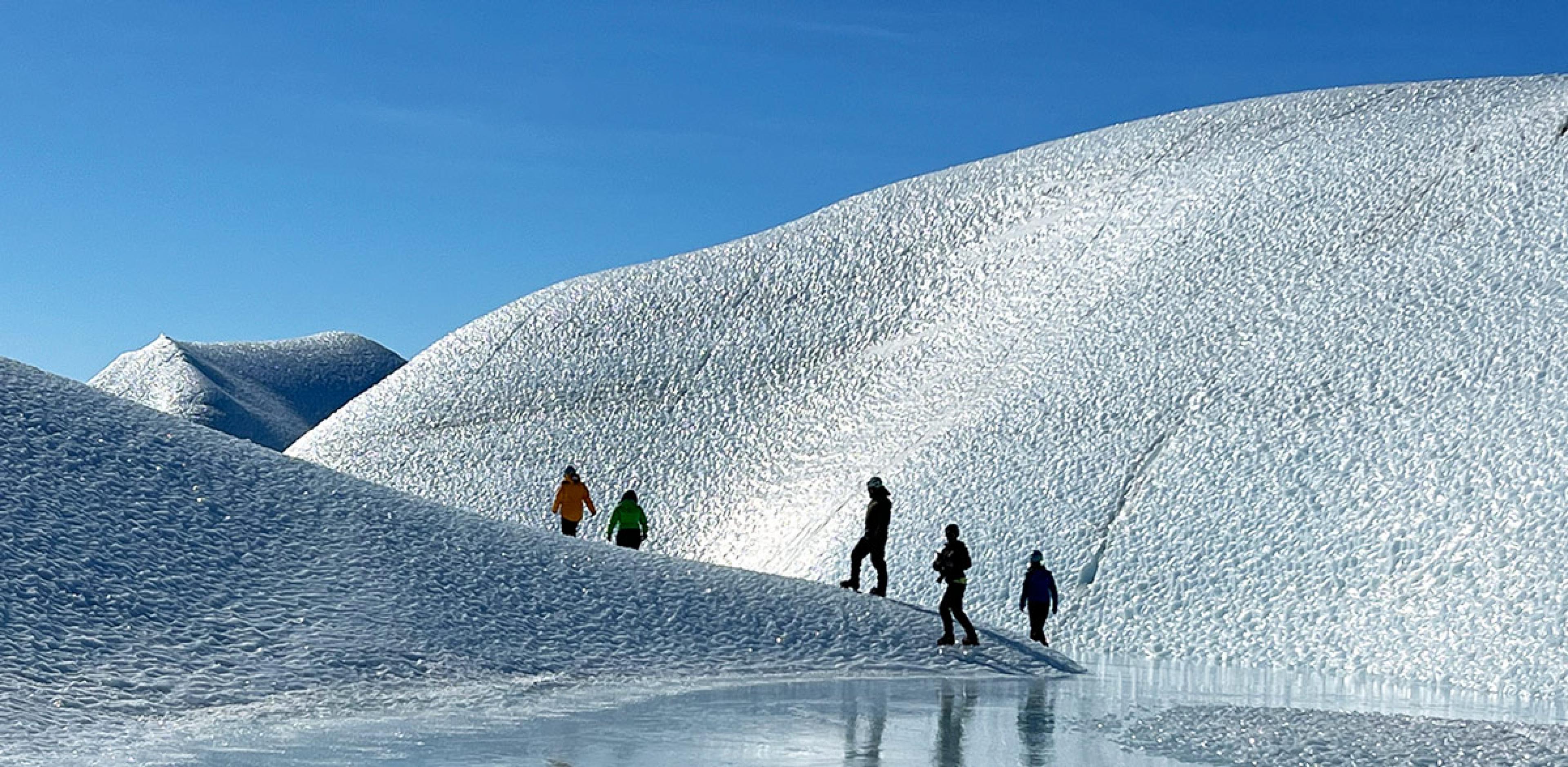 people climbing ice hill in antarctica