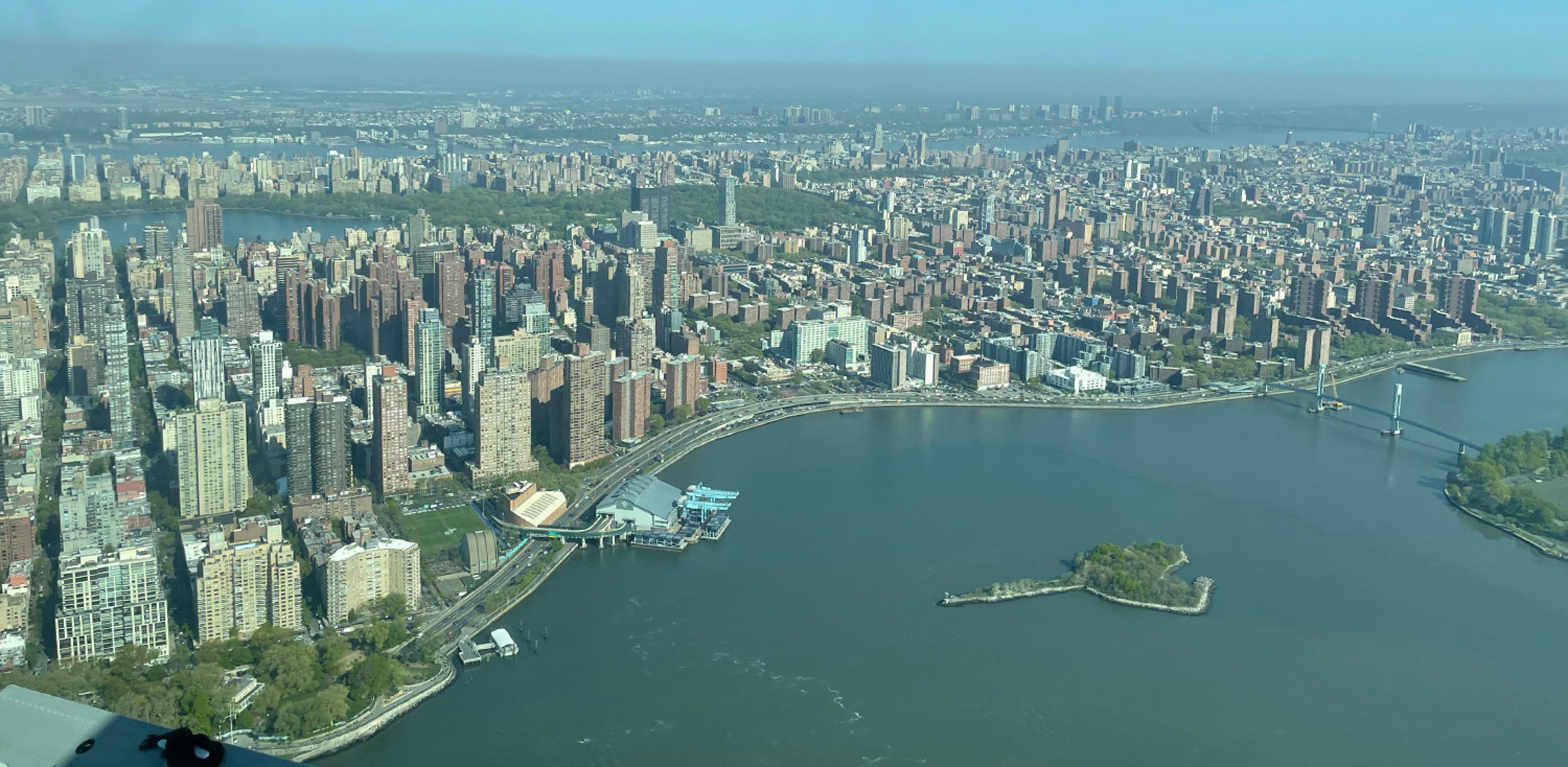 seaplane view over nyc as it takes off looking down over east side of city