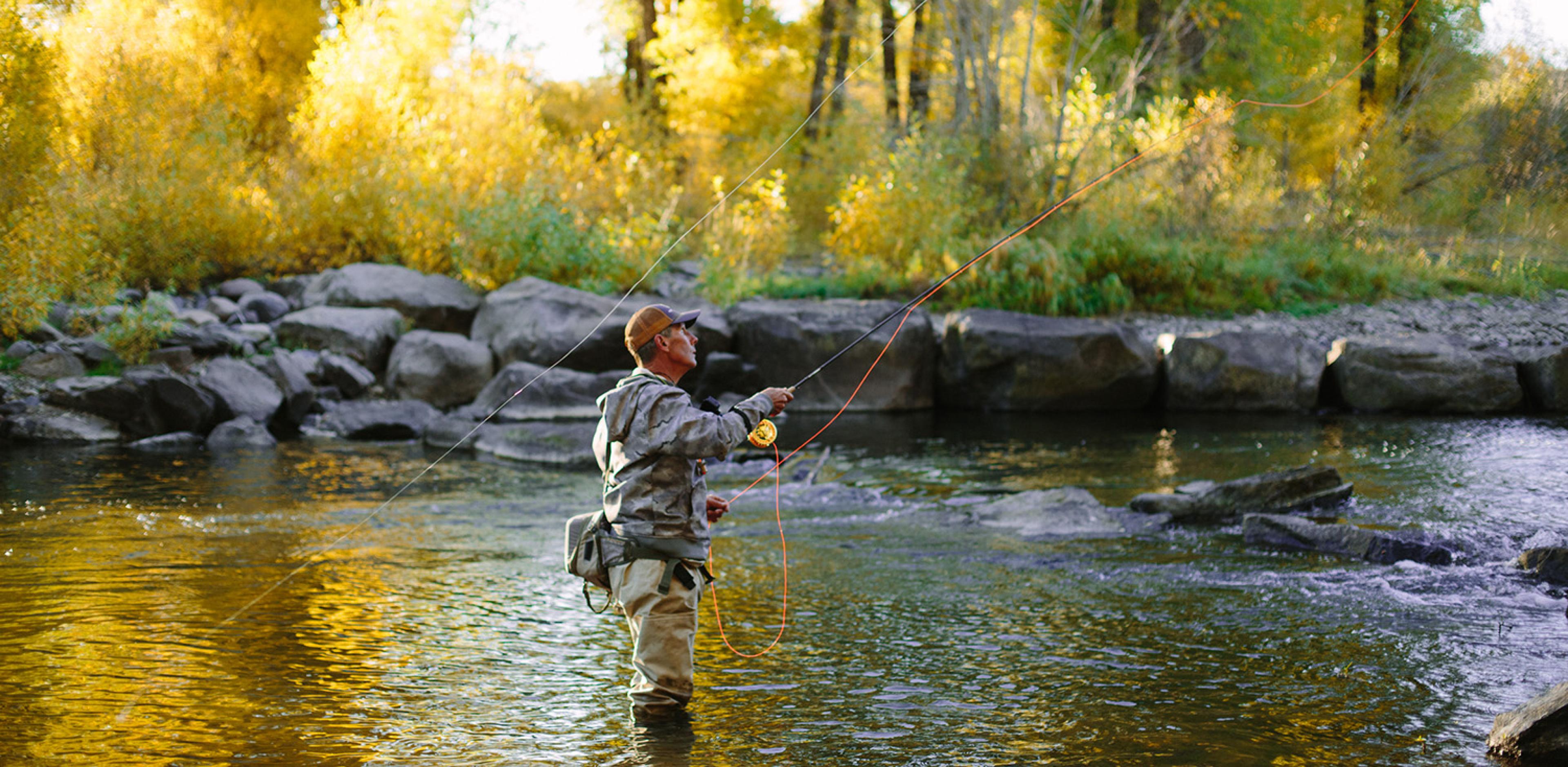 Man fly fishing in hip waters