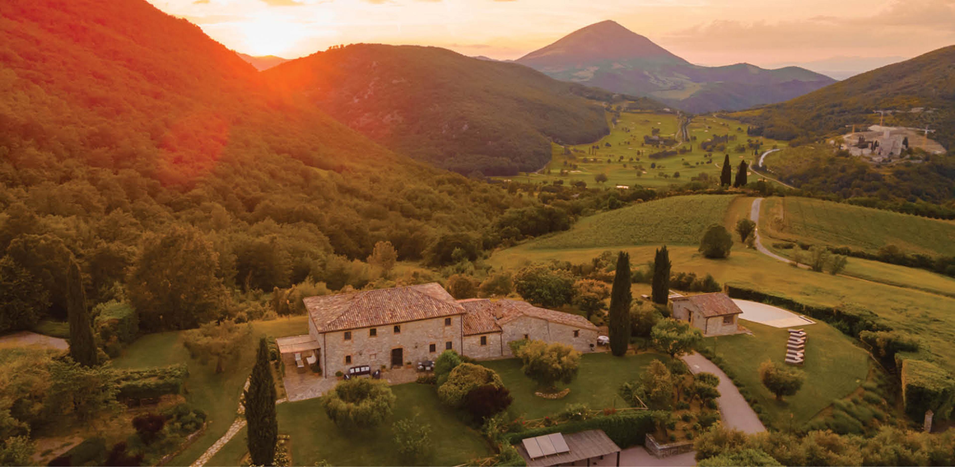 countryside with an Italian country house at sunset