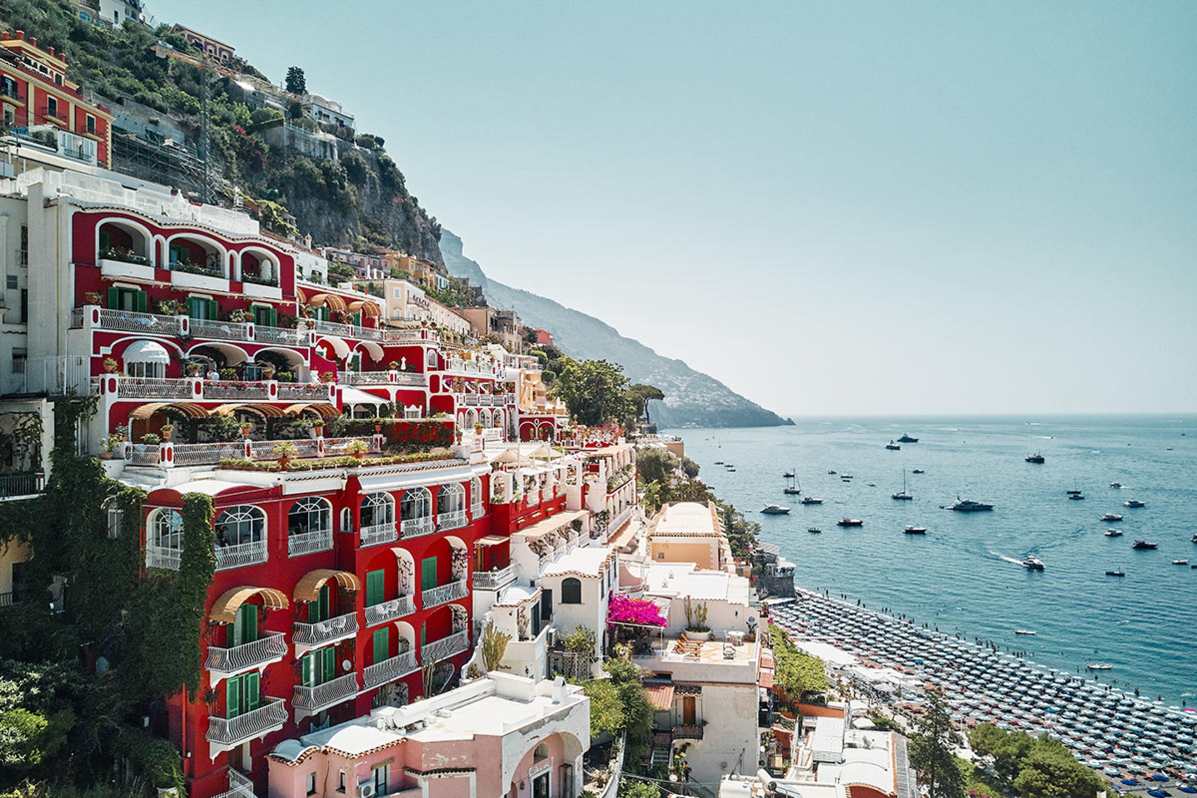 view of positano with red hotel building on left