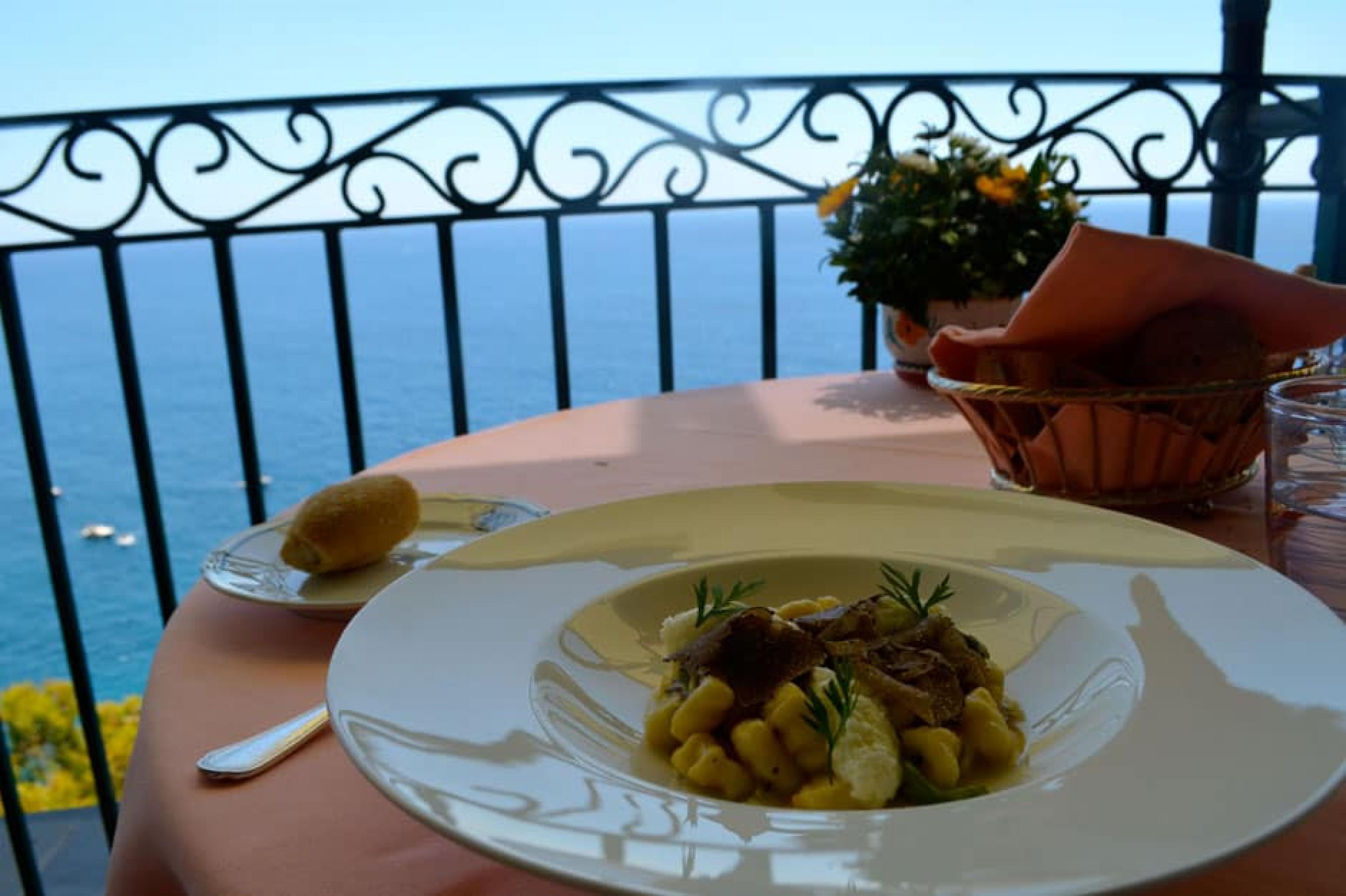 Food on table overlooking the ocean at Il San Pietro’s Zass, Amalfi Coast, Italy
