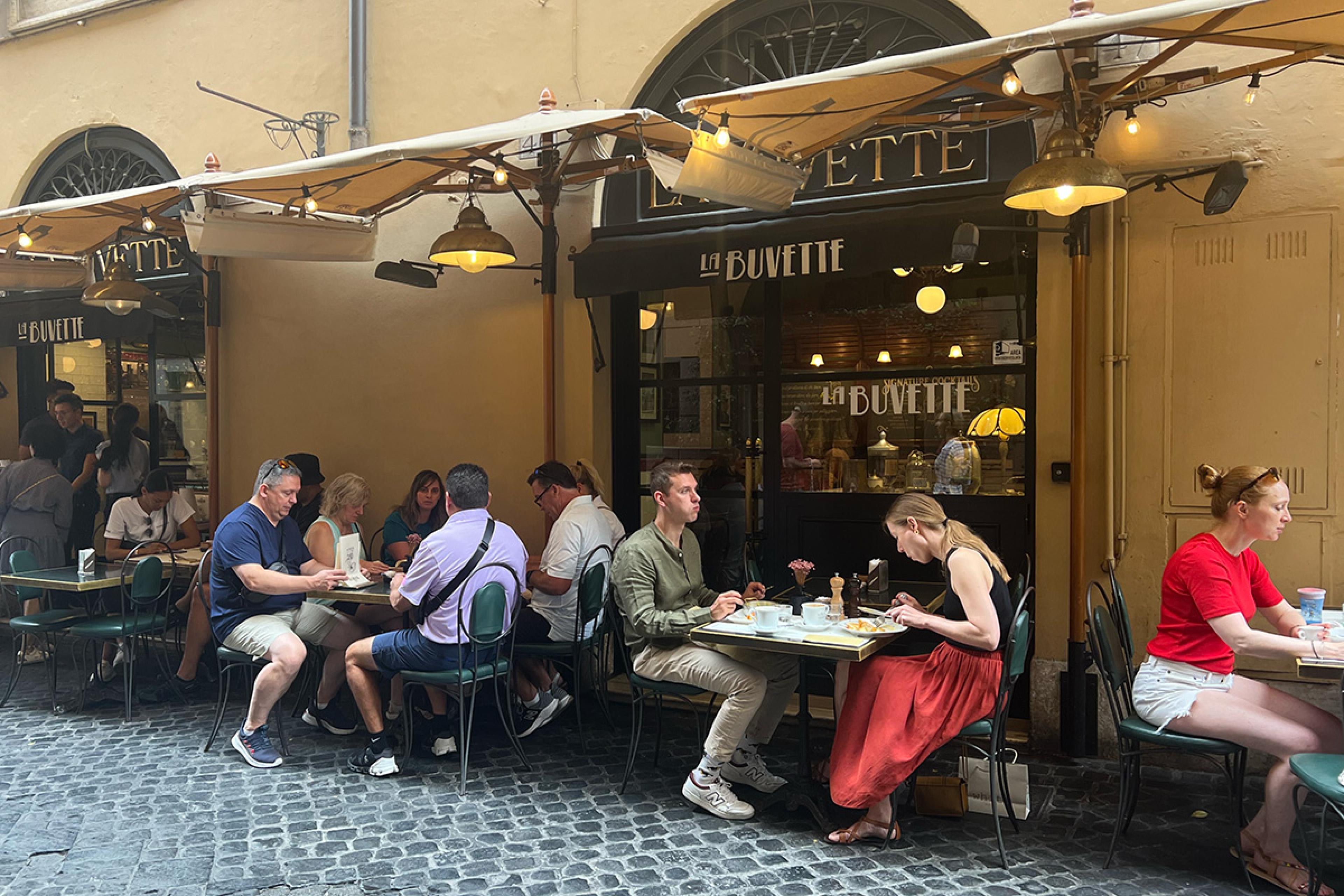 people dining outside on the cobblestones