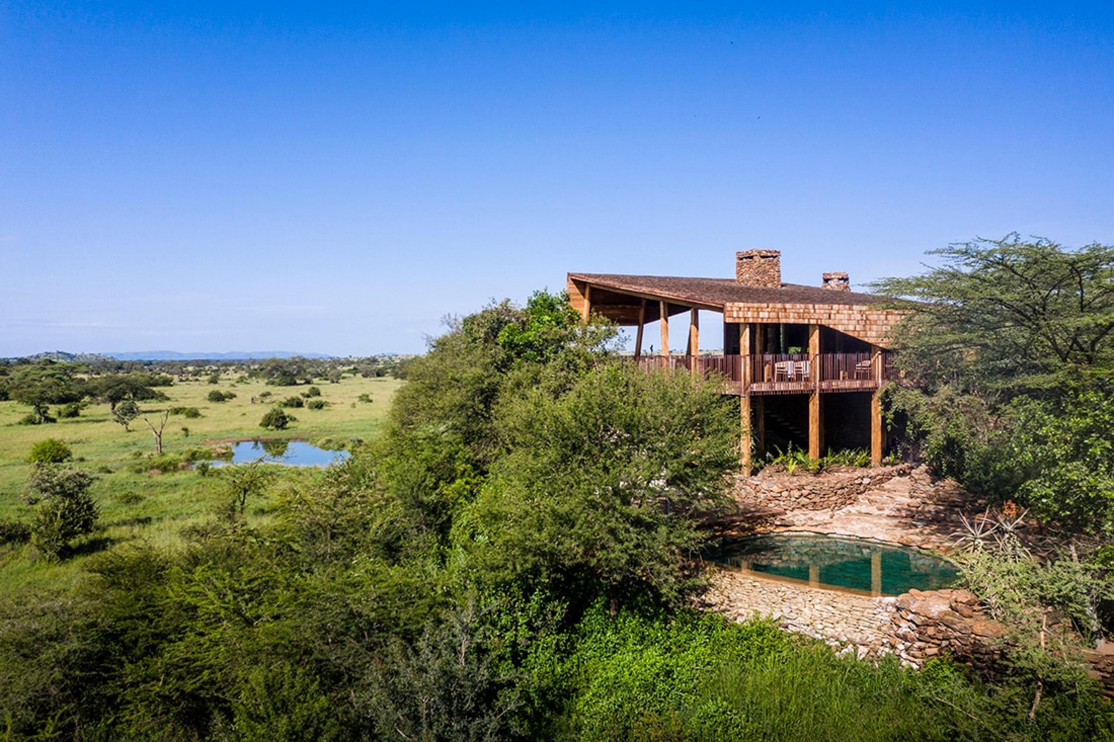 safari lodge aerial view with two-story building surrounded by trees